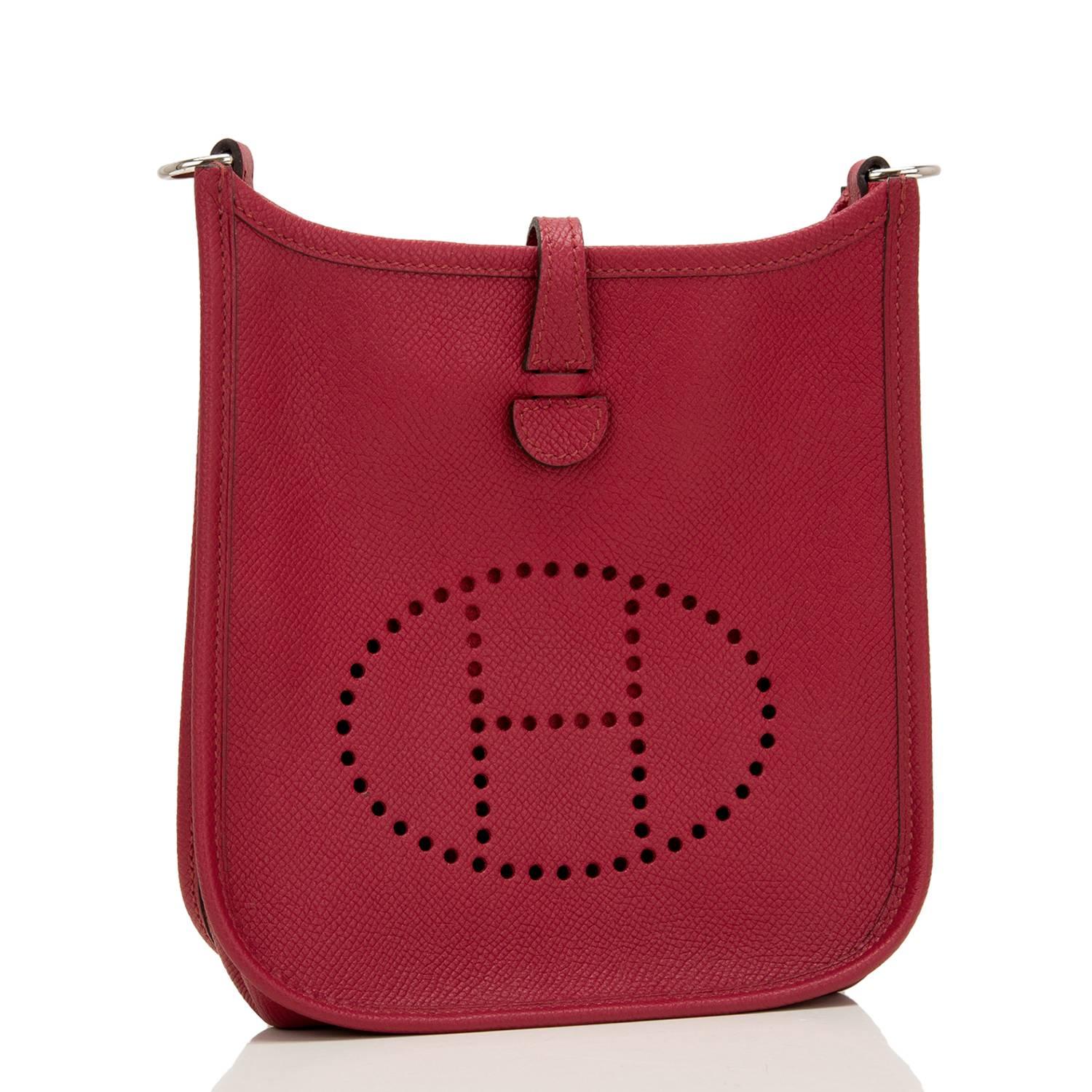 Hermes Rouge Grenat Evelyne III TPM of epsom leather with palladium hardware.

This tiny Evelyne has tonal stitching, a large perforated H icon in circle at front, a rear pocket, a pull tab top closure that has a snap closure at the rear, and a