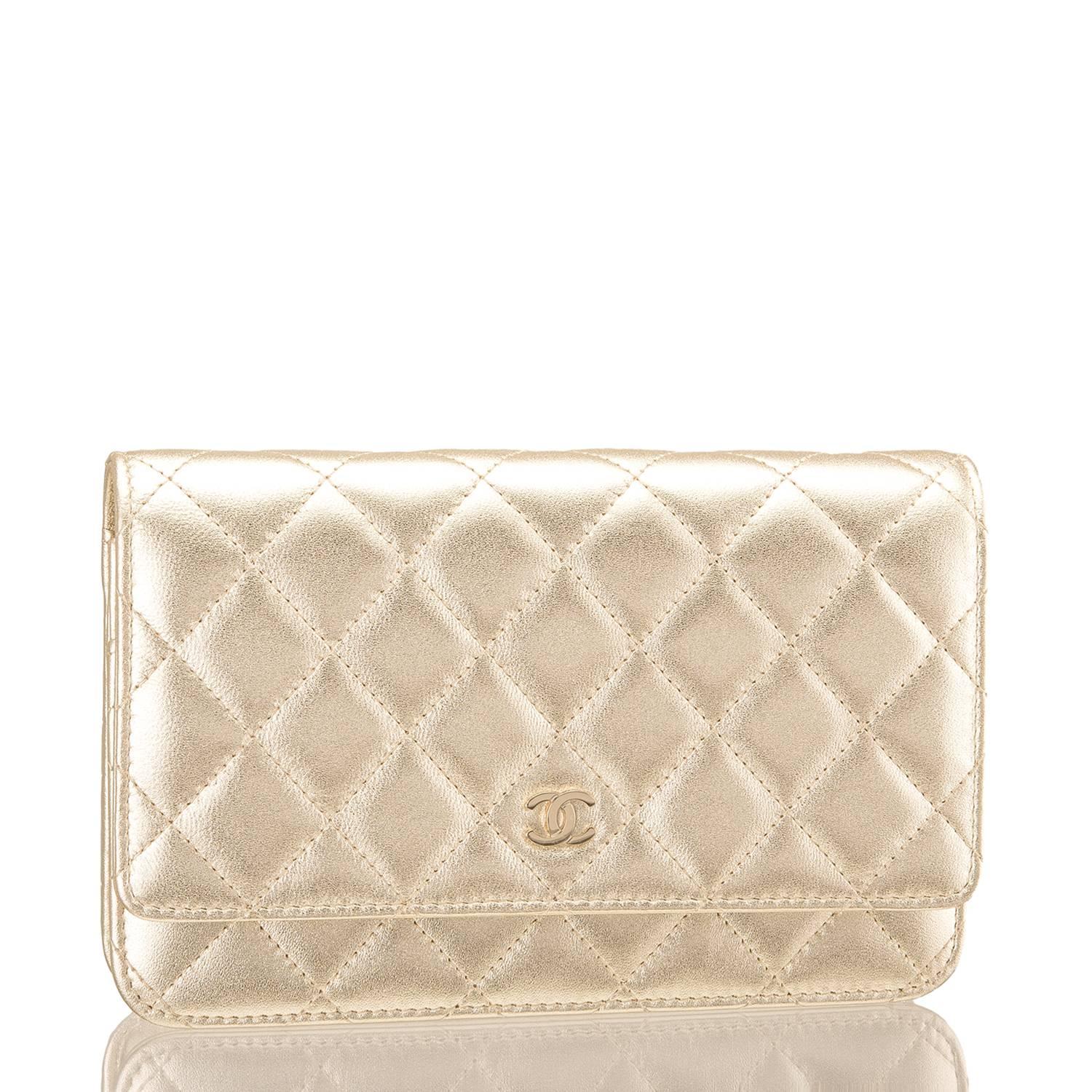 Chanel Classic Wallet on Chain (WOC) of gold lambskin leather with gold tone hardware. 

This Wallet On Chain features signature Chanel quilting, a front flap with CC charm and hidden snap closure, a half moon rear pocket and an interwoven gold