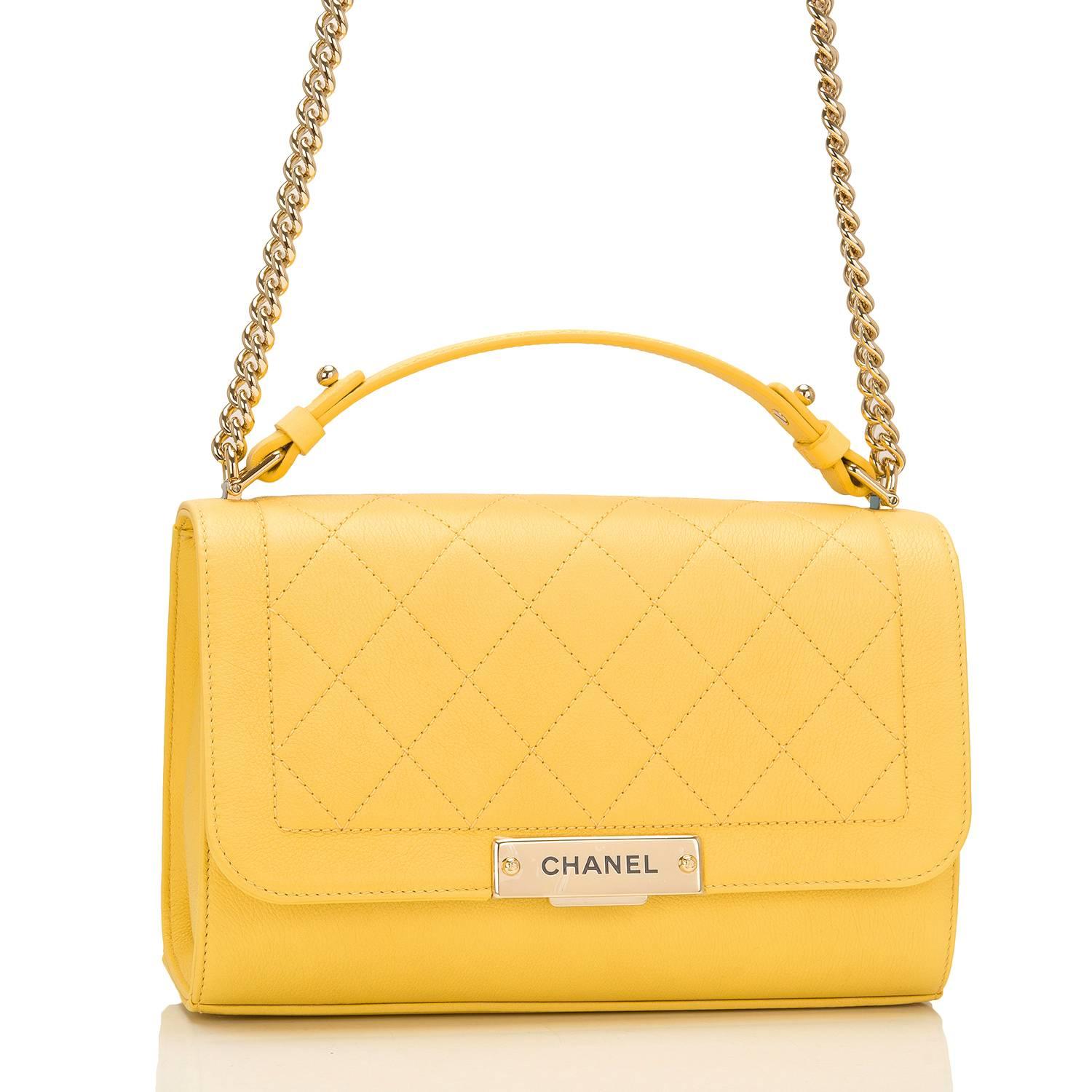 Chanel Medium Label Click Flap bag of quilted and smooth yellow grained calfskin leather and gold tone hardware.

This limited edition Chanel bag, from the 2017 cruise collection, features a front flap with push-lock closure, Chanel gold tone