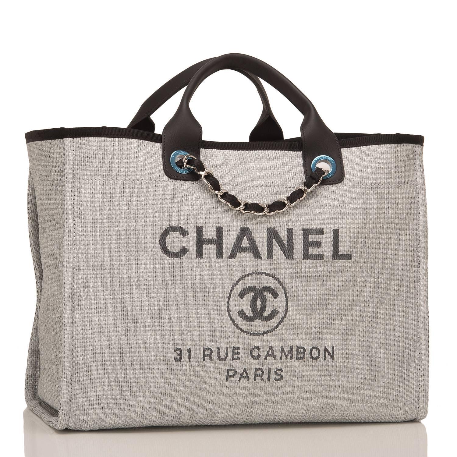 Chanel large Deauville shopping tote 30cm of grey canvas with silver tone hardware.

This bag features Chanel logos and the street name of Chanel's famous flagship store, 