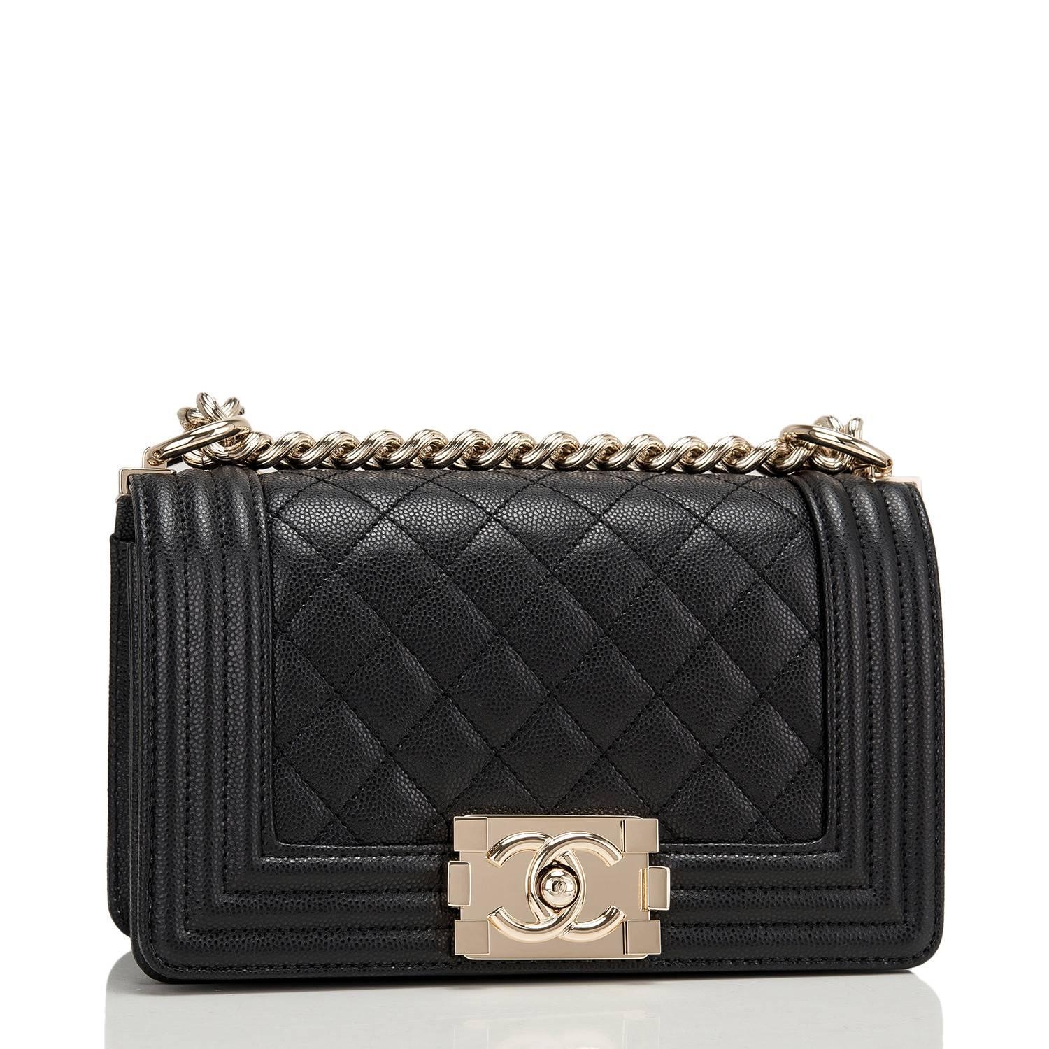 Chanel Small Boy bag of black caviar leather with light gold tone hardware.

This bag has a front flap with Le Boy CC push lock closure, smooth leather accents and light gold tone chain link and black leather padded shoulder strap.

The interior is