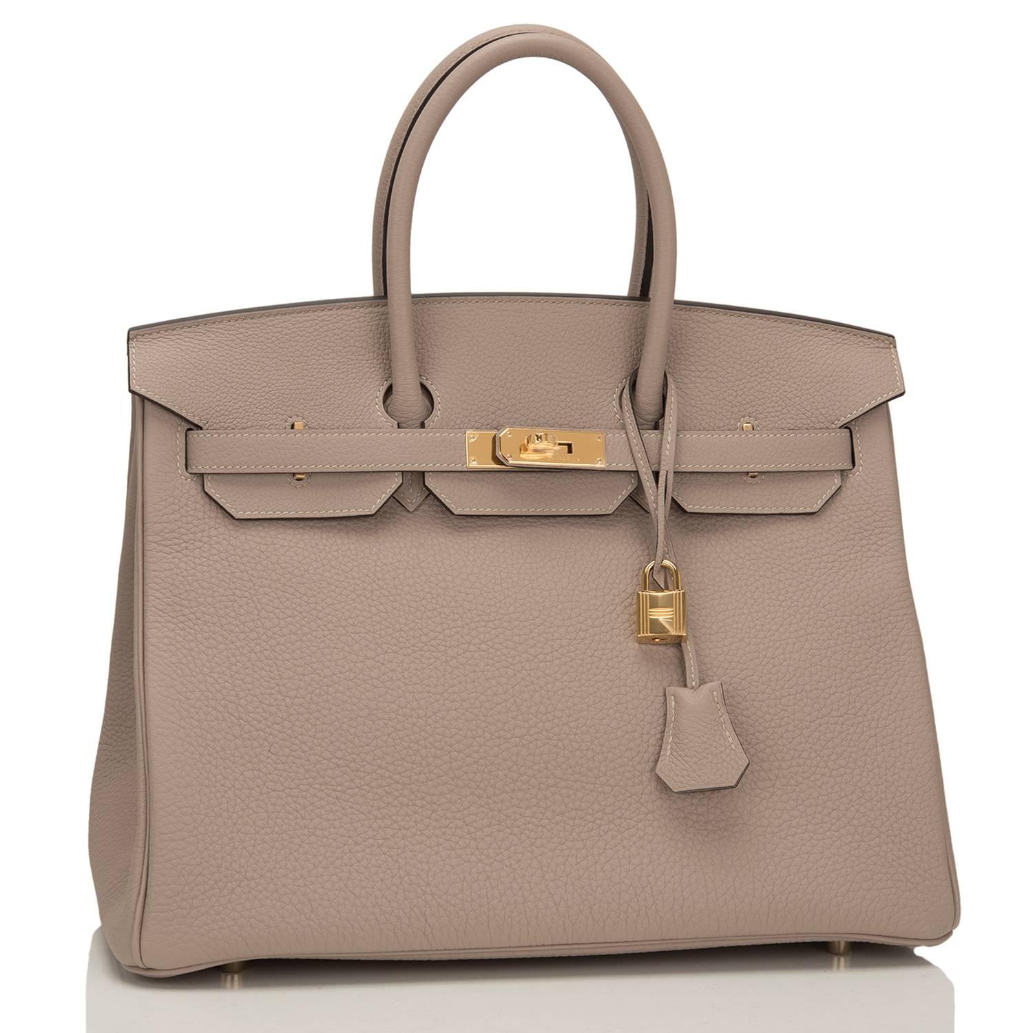 Hermes Gris Tourterelle Birkin 35cm in togo leather with gold hardware.

This Birkin features tonal stitching, front toggle closure, clochette with lock and two keys, and double rolled handles.

The interior is lined in Gris Tourterelle chevre with