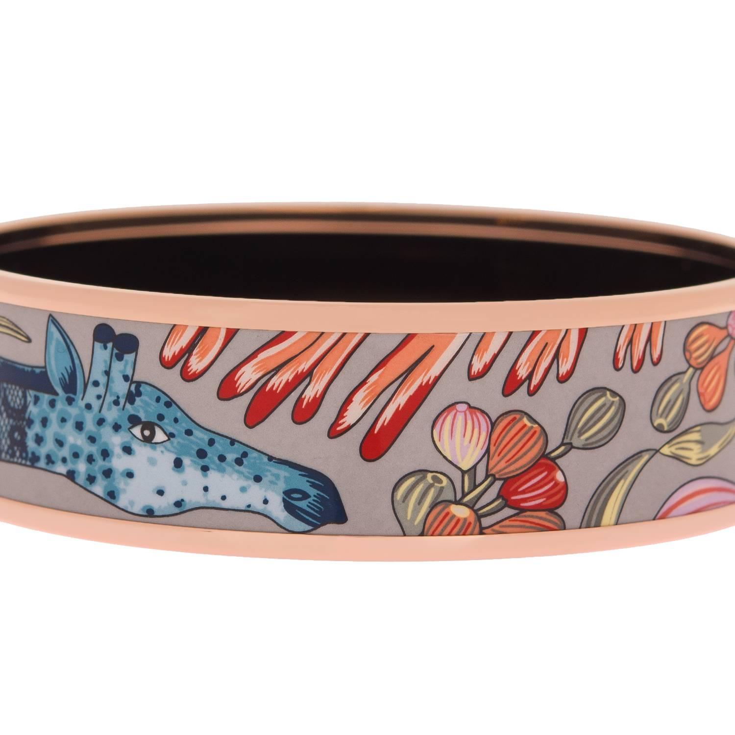 Hermes "La Marche De Savanna" wide printed enamel bracelet size PM (65).
 
This bracelet depicts a giraffe and flowers in a blue background with rose gold plated hardware. 

Origin: France
 
Condition: Never Worn
 
Accompanied by: Hermes