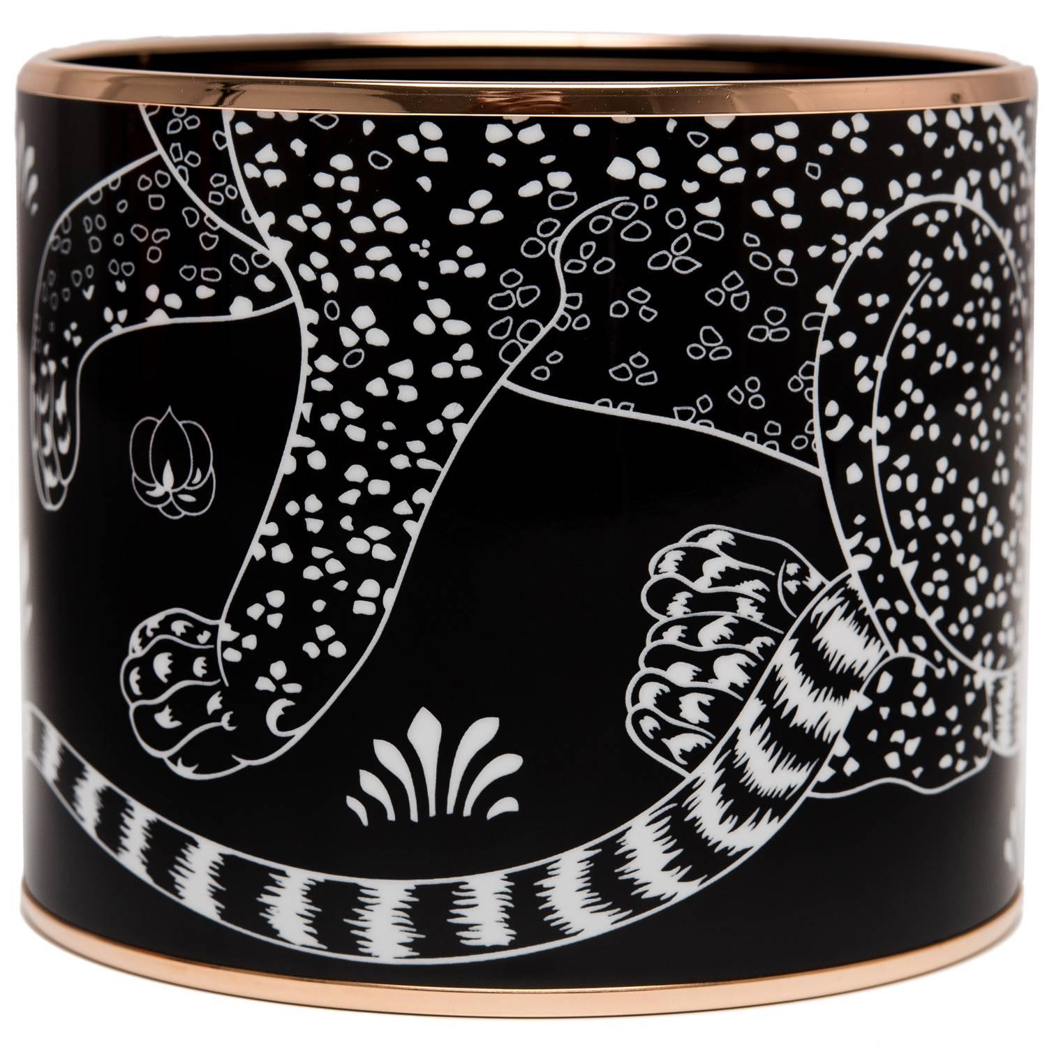 Hermes "Les Leopards" mega enamel bracelet size PM (65) depicting leopards and flowers in a black background with rose gold plated hardware.

Origin: France
 
Condition: Pristine, never worn
 
Accompanied by: Hermes box, Hermes dustbag,