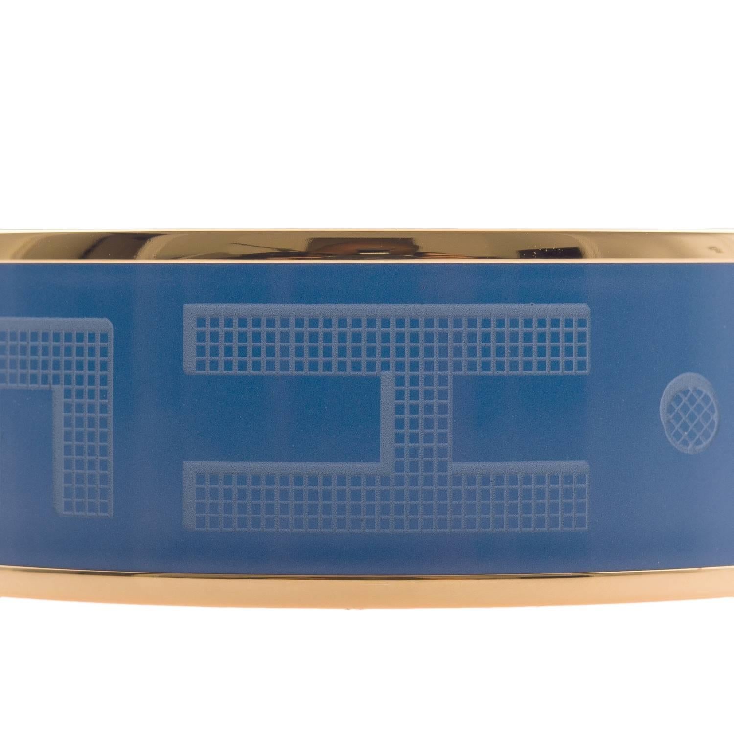 Hermes "Sellier" wide printed enamel bracelet size PM (65).
 
This bracelet depicts "Hermes" on a blue colored background with gold plated hardware.

Origin: France
 
Condition: Pristine
 
Accompanied by: Hermes box, dustbag and