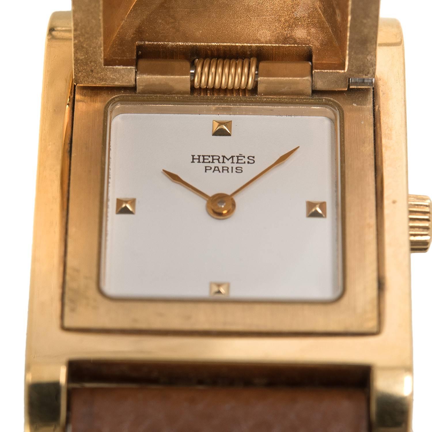 Hermes Medor watch in Gold courcheval in a size PM.

This stunning style made of gold plated stainless steel features swiss quartz movement, white dial, sapphire crystal push-pull crown, and adjustable Gold courcheval band with an Hermes stamped