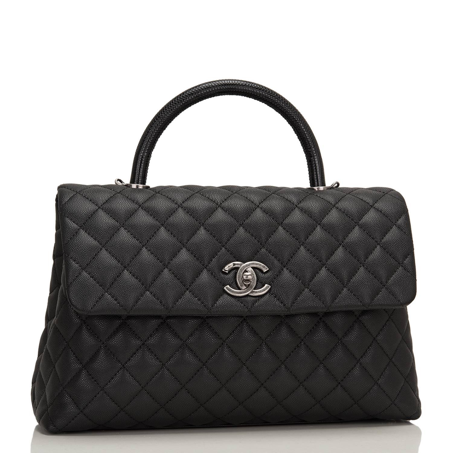 Chanel large Coco handle flap bag of black calfskin leather and lizard handle with ruthenium hardware.

This rare bag has the signature diamond quilting in a trapezoidal shape with signature CC interlocking closure, lizard top handle, and long