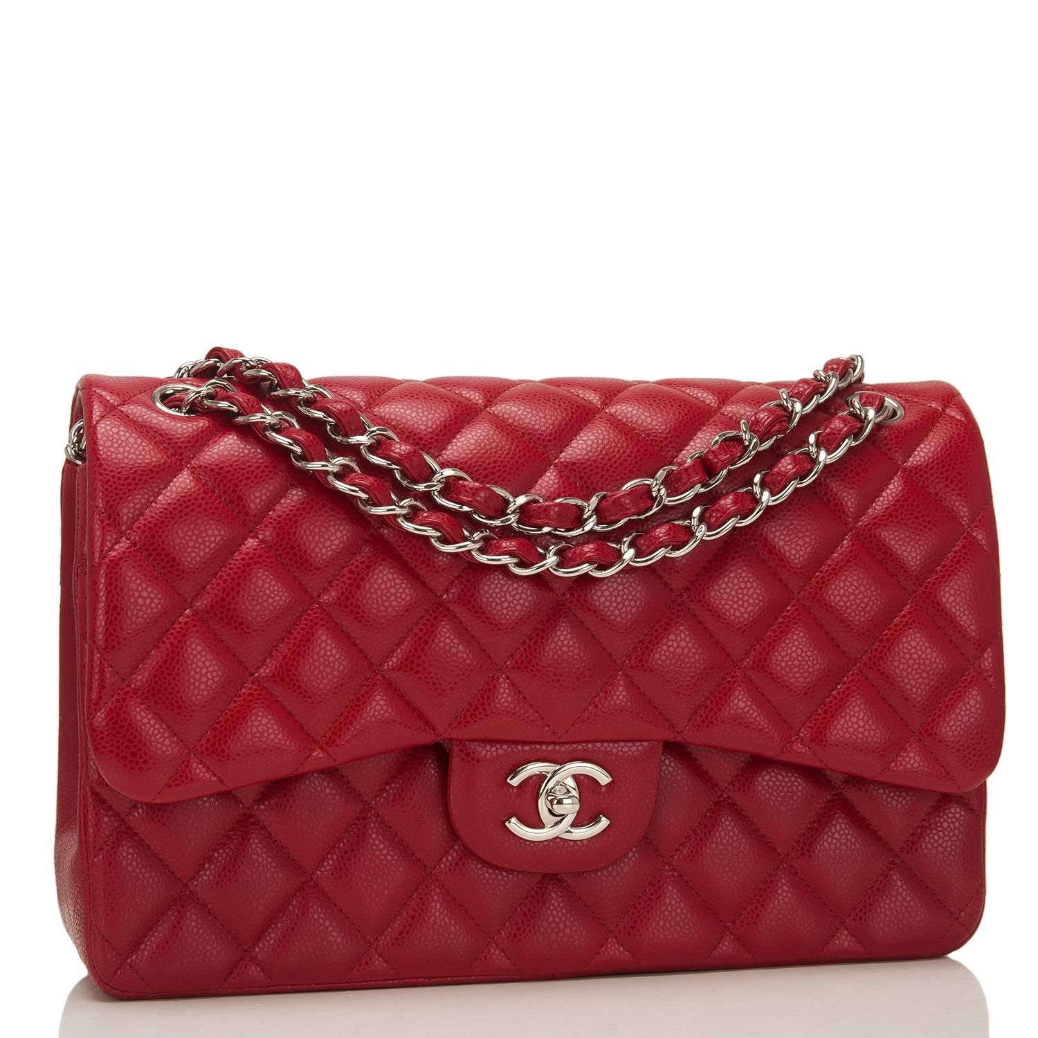 Chanel Jumbo Classic double flap bag of red caviar leather with silver tone hardware.

This bag features a front flap with signature CC turnlock closure, a half moon back pocket, and an adjustable interwoven silver tone chain link and dark red