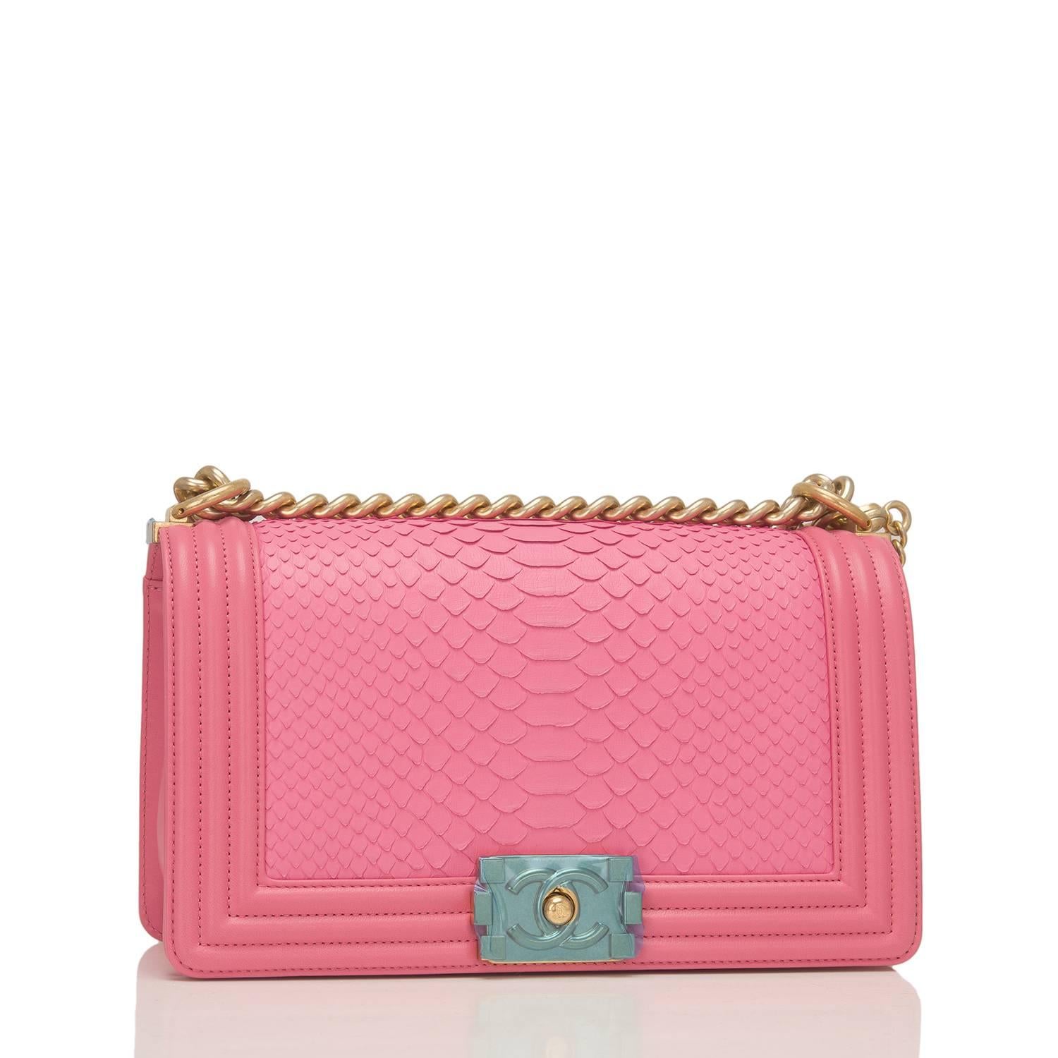 Chanel Medium Boy bag of pink python and gold tone hardware.

This Chanel bag is in the classic Boy style with a full front flap with the Boy signature CC push lock closure detail, lambskin leather accents and gold tone chain link with pink leather
