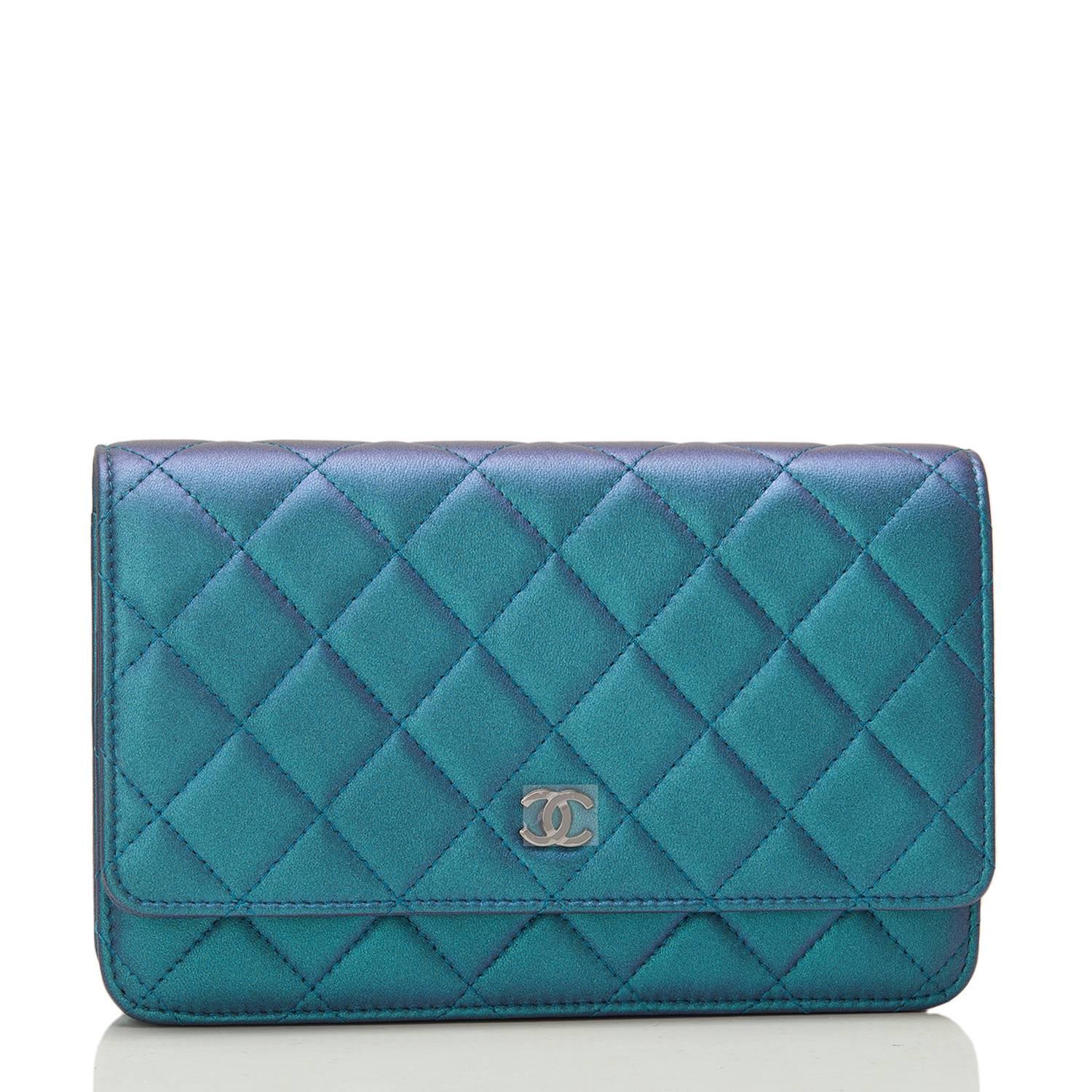 Chanel Classic Wallet on Chain (WOC) of iridescent turquoise lambskin leather with silver tone hardware. 

This Wallet On Chain features signature Chanel quilting, a front flap with CC charm and hidden snap closure, a half moon rear pocket and an