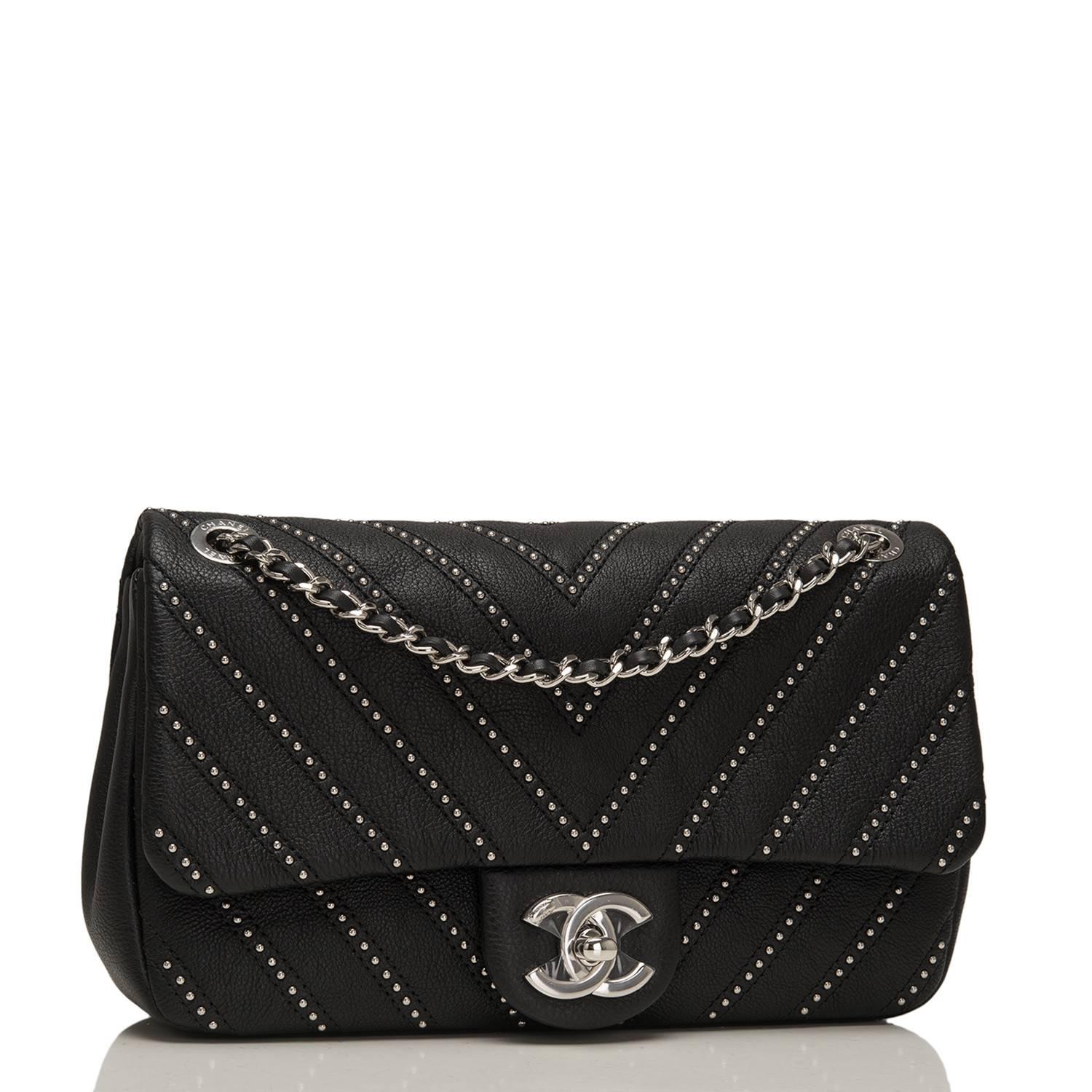 Chanel flap bag of black studded calfskin leather with silver tone hardware.

This bag has a front flap with signature CC turnlock closure, rear half moon pocket and single interwoven black leather and silver tone chain link shoulder/crossbody strap