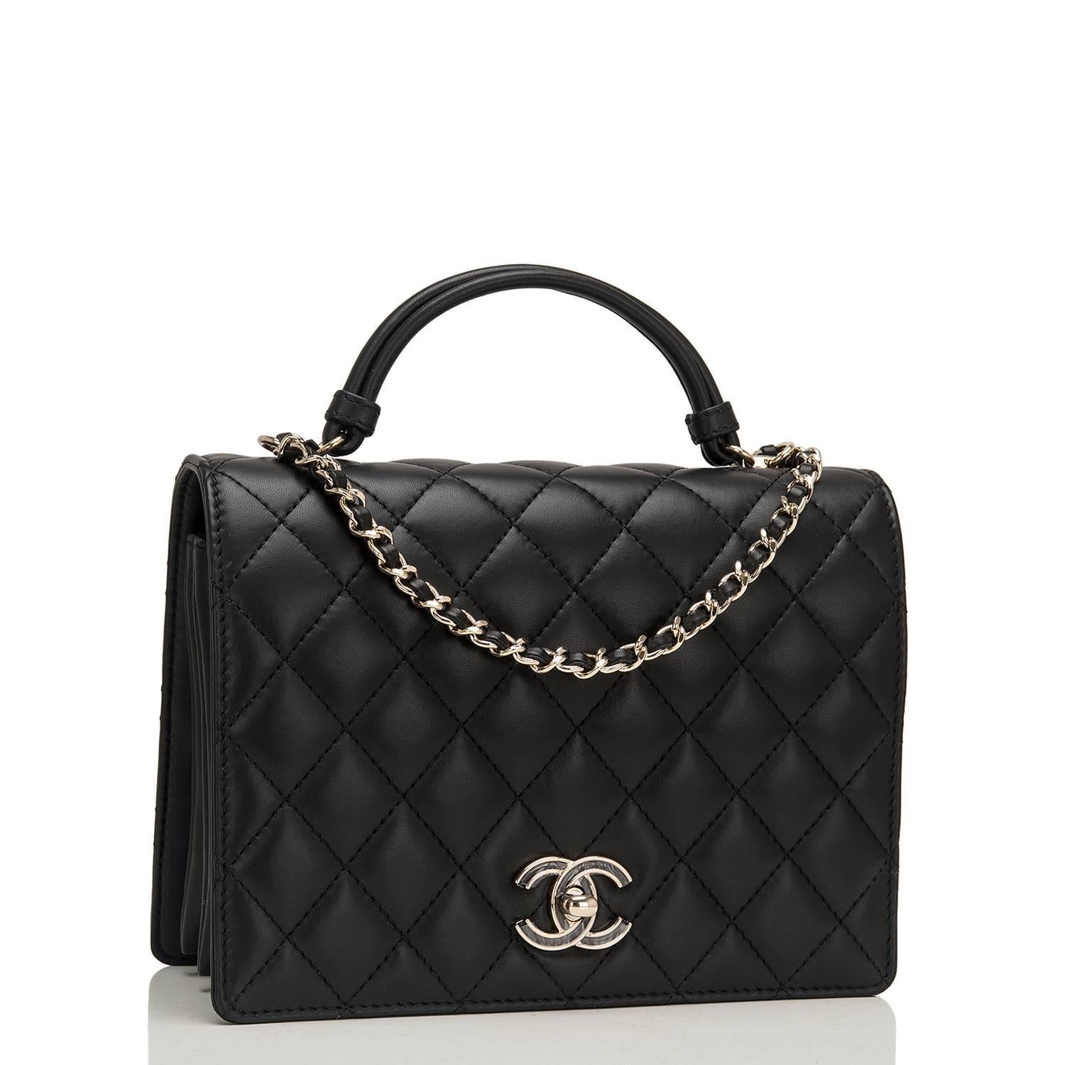 Chanel Handle Tied of black quilted lambskin leather with gold tone hardware.

This bag features a front flap with CC turnlock closure, back pocket, interwoven gold and black leather chain with shoulder pad and a single 