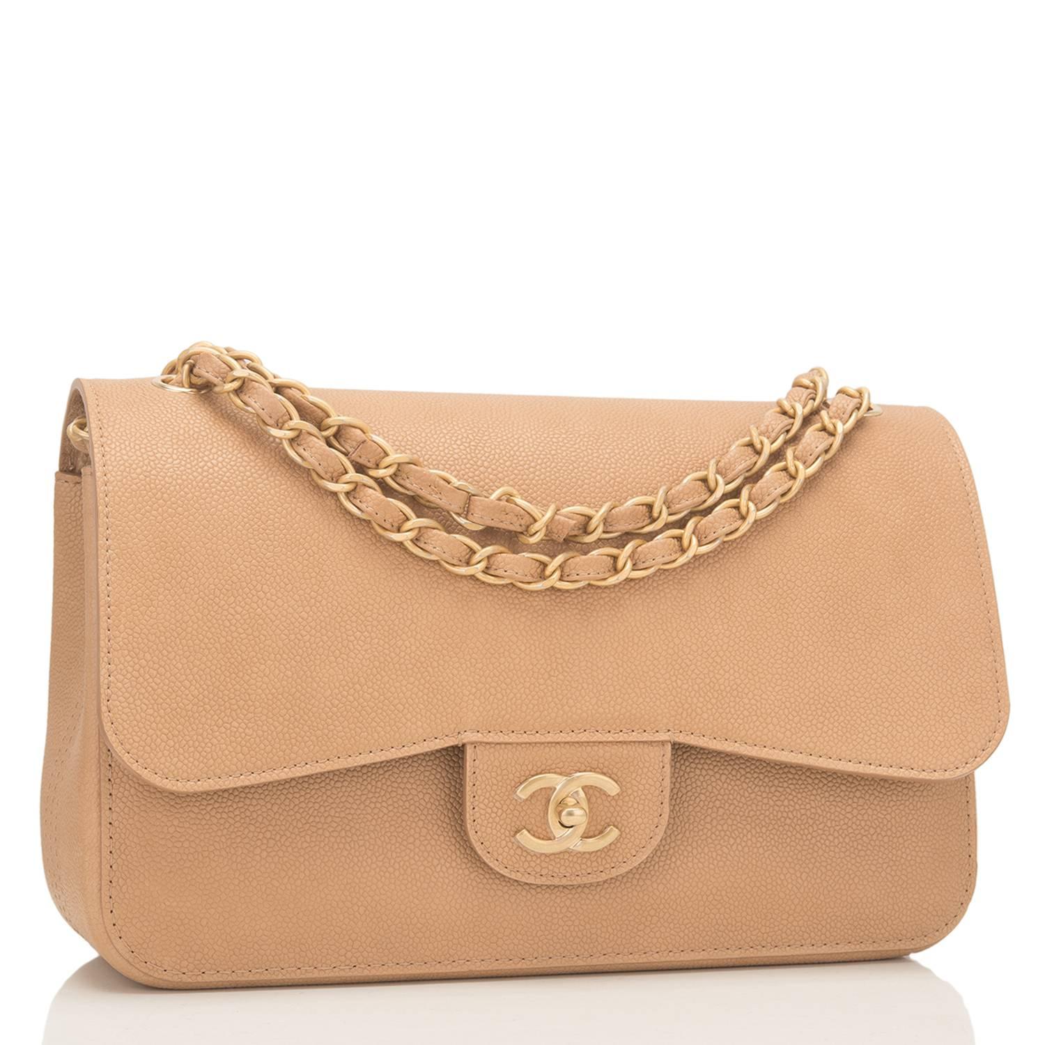 Chanel Jumbo Classic Double Flap bag of beige unquilted caviar (grained calfskin) leather and accented with gold tone hardware.

This bag features a front flap with signature CC turnlock closure, a half moon back pocket, and an adjustable interwoven