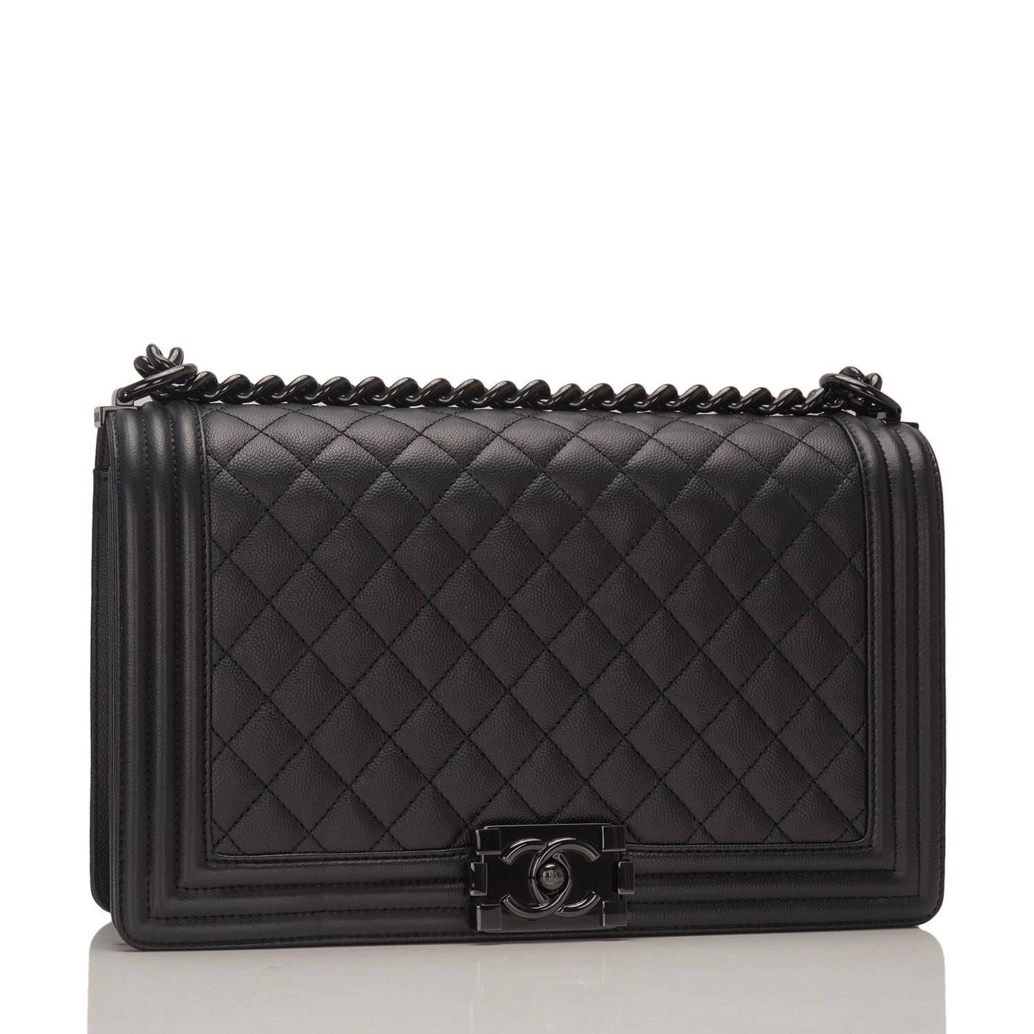 Chanel New Medium Boy bag of black quilted grained lambskin and black hardware.

This Chanel bag is in the classic Boy style with a full front flap with the Boy signature CC push lock closure detail and black chain link and black leather padded