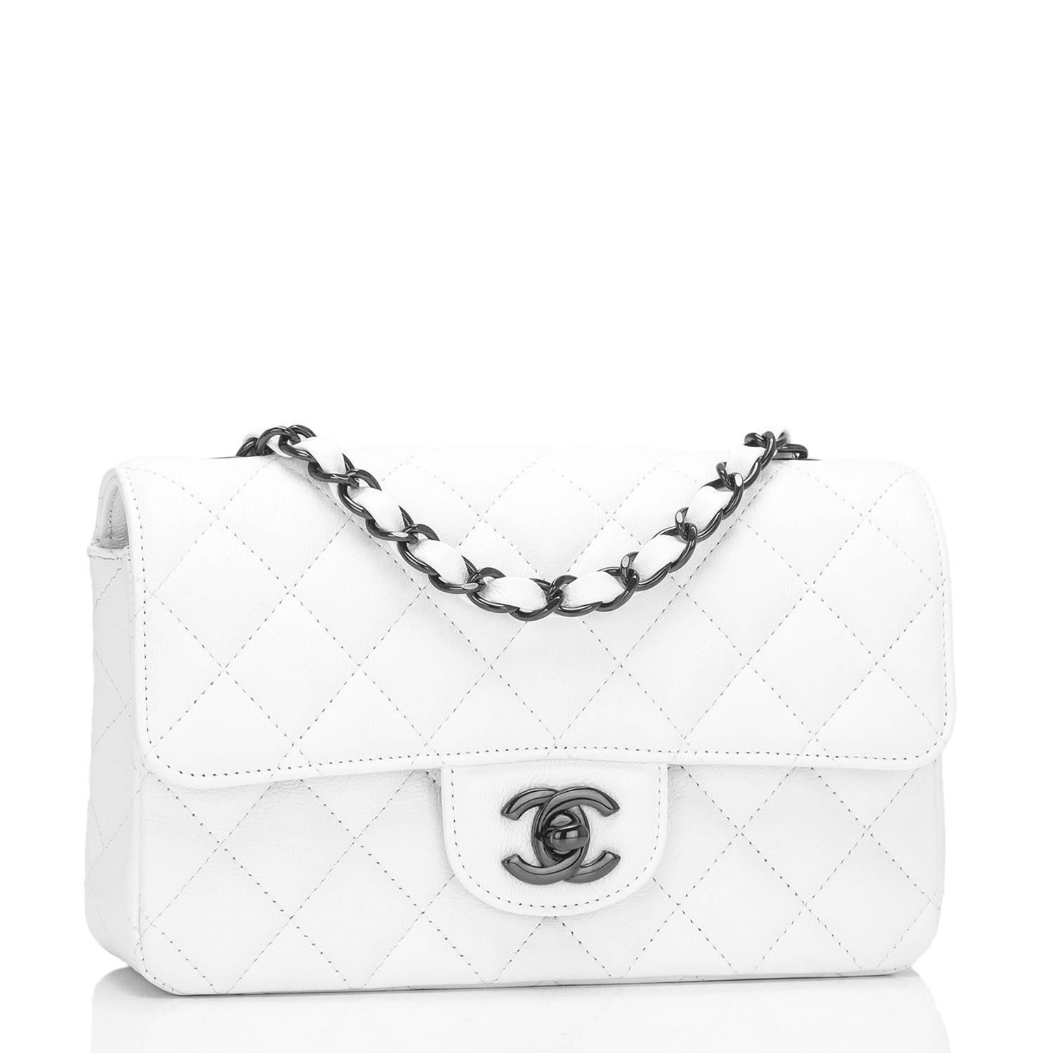 Chanel Rectangular Mini Classic flap bag of white crumpled calfskin leather with black hardware.

This limited edition bag has a front flap with signature CC turnlock closure, rear half moon pocket and single interwoven white leather and black chain
