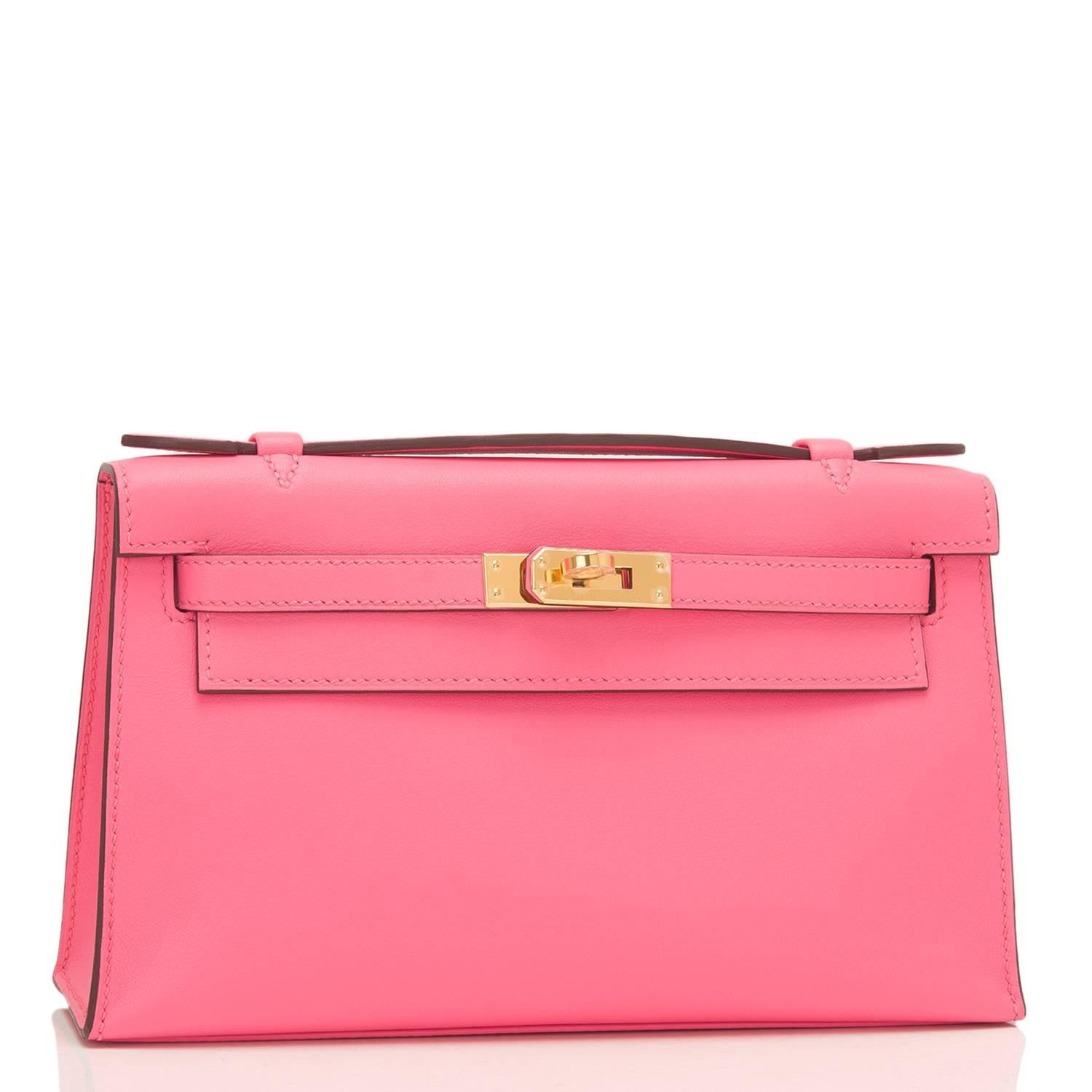 Hermes Rose Azalea (Azalee) Mini Kelly Pochette of swift leather with gold hardware.

This Hermes pochette has tonal stitching, a front flap with two straps, a toggle closure and a single flat handle.

The interior is lined with Rose Azalea chevre