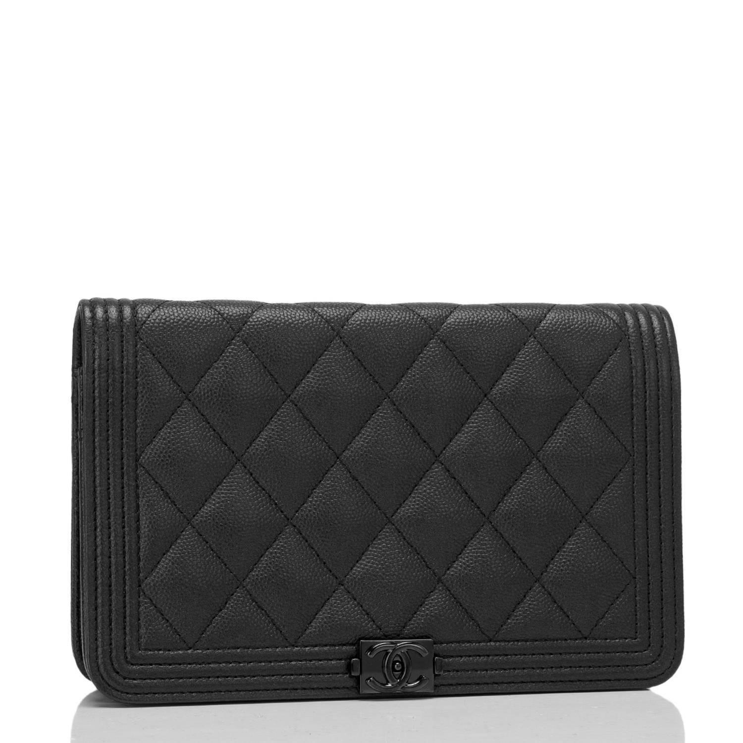 Chanel quilted Boy Wallet on Chain (WOC) of black caviar leather with black hardware.

This Wallet On Chain features a front flap with the signature Le Boy CC charm and hidden snap closure and a black metal chain link with black leather