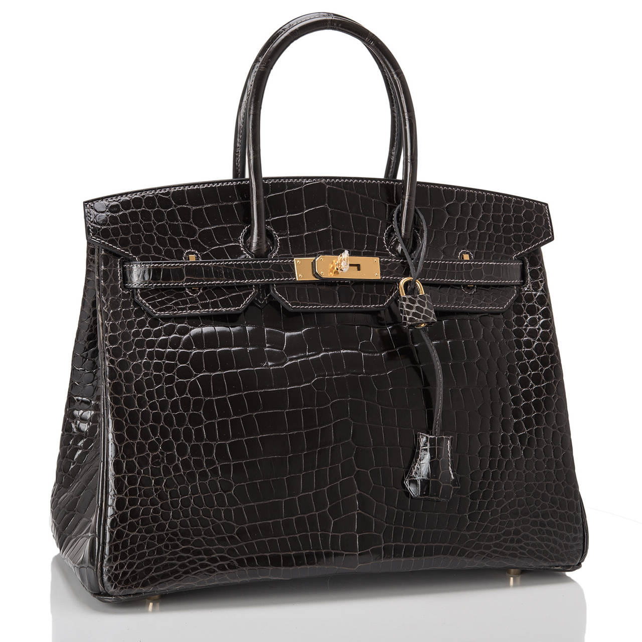 Hermes Graphite Birkin 35cm in Porosus crocodile with gold hardware.

This Birkin features tonal stitching, front toggle closure, clochette with lock and two keys, and double rolled handles. The interior is lined in Graphite chevre with one zip