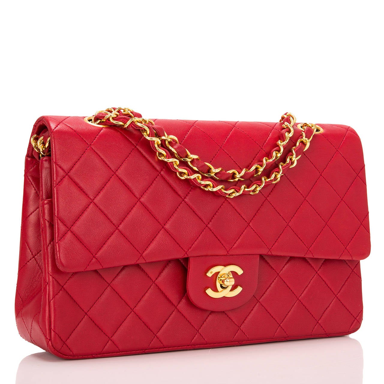 This rare and beautiful vintage Chanel lipstick red Large Classic double flap bag in near mint condition demonstrates the timelessness of the Chanel Classic. This is made of quilted lambskin leather with gold tone hardware. As with all Chanel