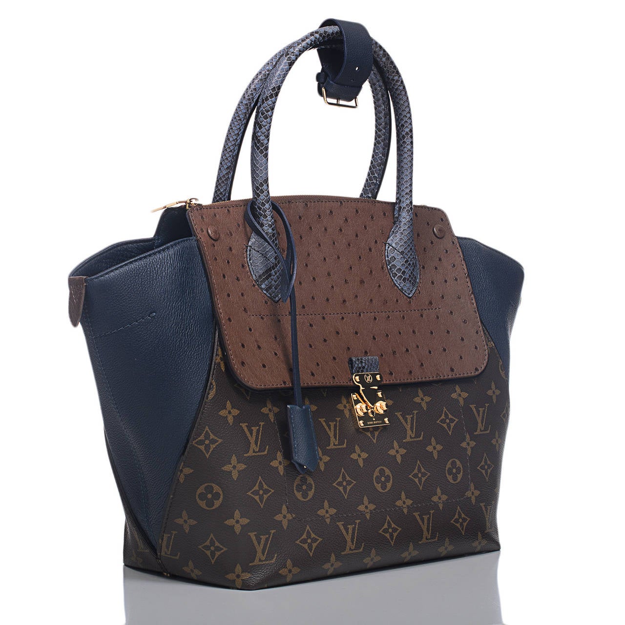 Louis Vuitton Bleu Exotic Monogram Majestueux MM Tote with golden brass hardware.

This chic shopper features coated canvas with expandable blue calfksin leather sides, ostrich trim, double rolled python handles, and an external front pocket with