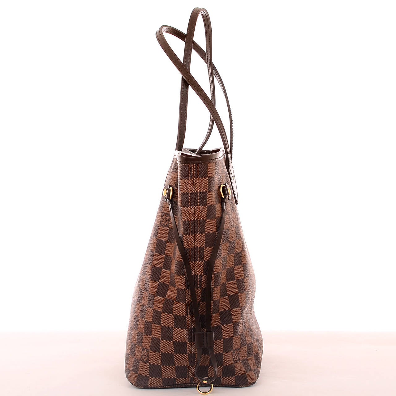 Louis Vuitton dark and light brown checkered Damier Ebene Neverfull MM of coated canvas with smooth brown leather trim.

This classic tote features polished brass hardware, adjustable drawstring sides, hidden top hook closure and double flat