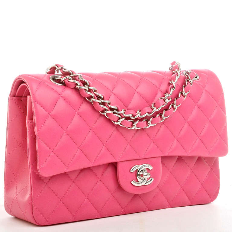 Chanel fuchsia pink lambskin quilted leather large 2.55 double flap with silvertone hardware, front flap with CC turnlock closure, half moon back pocket and interwoven silvertone chan link and fuchsia leather adjustable shoulder strap. Interior is
