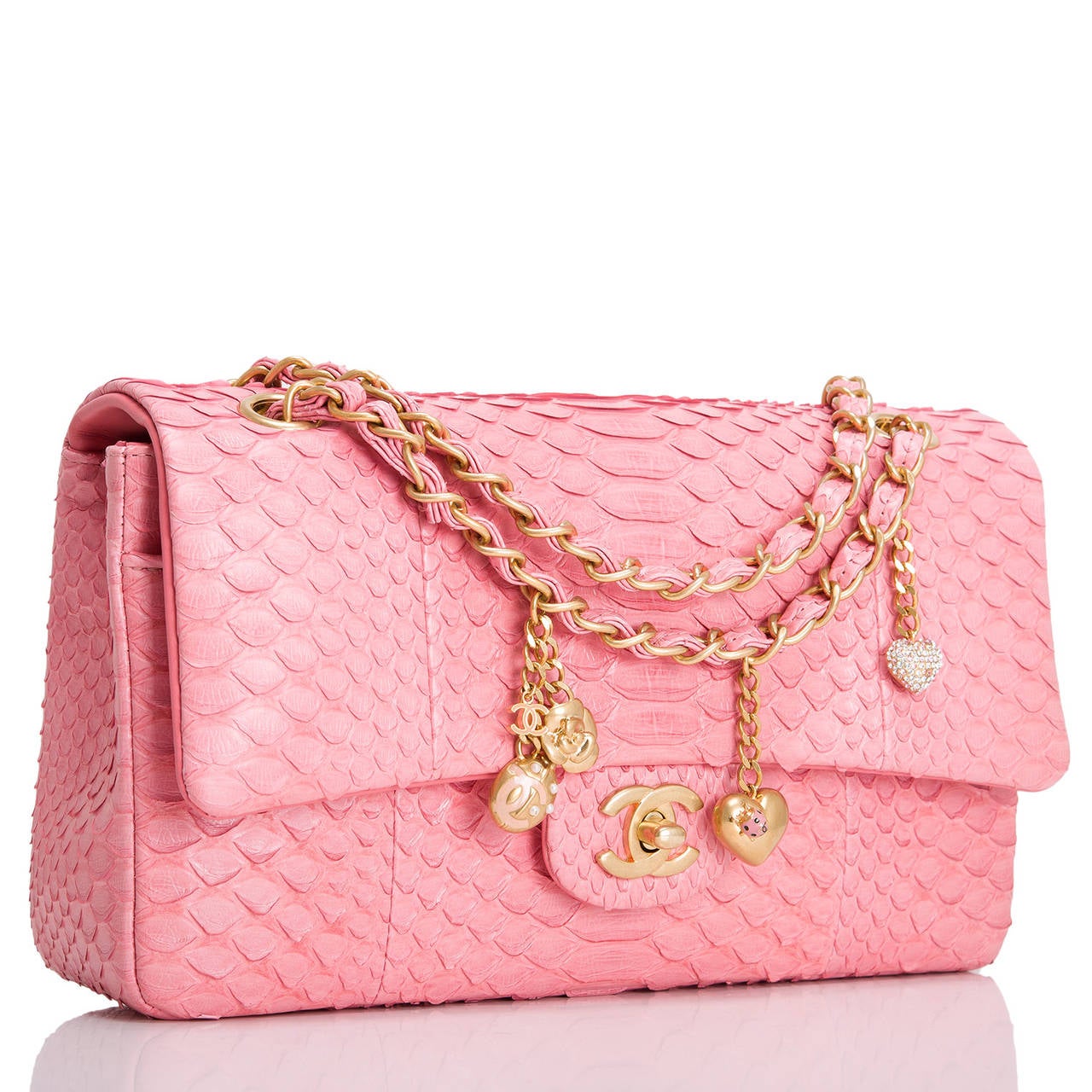 This pink python Chanel Large Charm Classic Flap features a front flap with signature CC turnlock closure, half moon back pocket and an adjustable interwoven aged gold tone chain link and pink python leather shoulder strap.

The interior is lined
