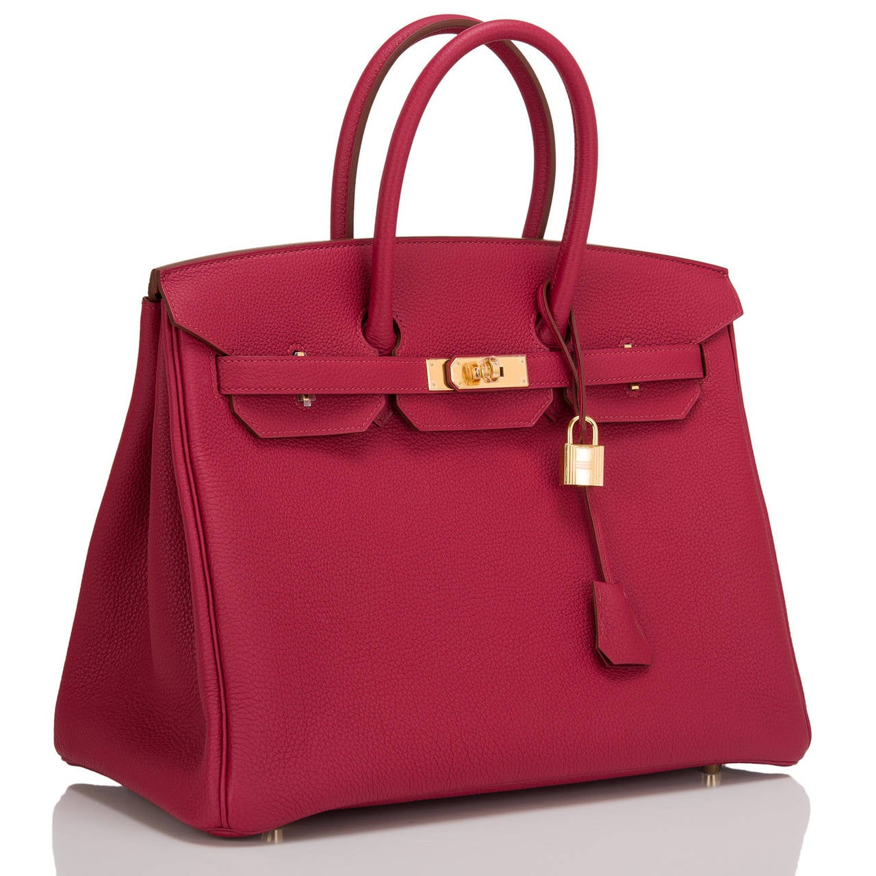 Hermes Rubis Birkin 35cm in togo (bull) leather with gold hardware.

This Birkin features tonal stitching, front toggle closure, clochette with lock and two keys, and double rolled handles. The interior is lined in Rubis chevre with one zip pocket