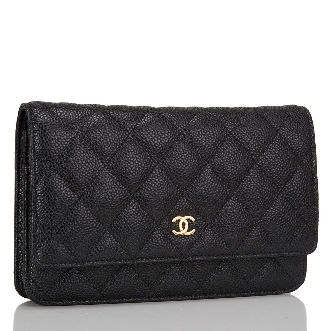 This timeless WOC style is exceptional in that it features gold tone hardware. The bag is made of black caviar leather and has the signature Chanel quilting, front flap with CC charm and hidden snap closure, expandable sides and bottom, half moon