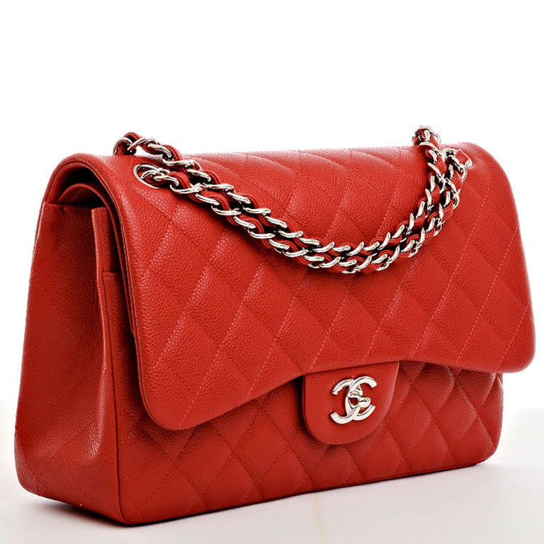 Chanel lipstick red quilted caviar leather Jumbo 2.55 double flap bag with silvertone hardware, front flap with CC turn lock closure, half moon back pocket, adjustable interwoven silvertone chain link and red leather shoulder strap, and red leather
