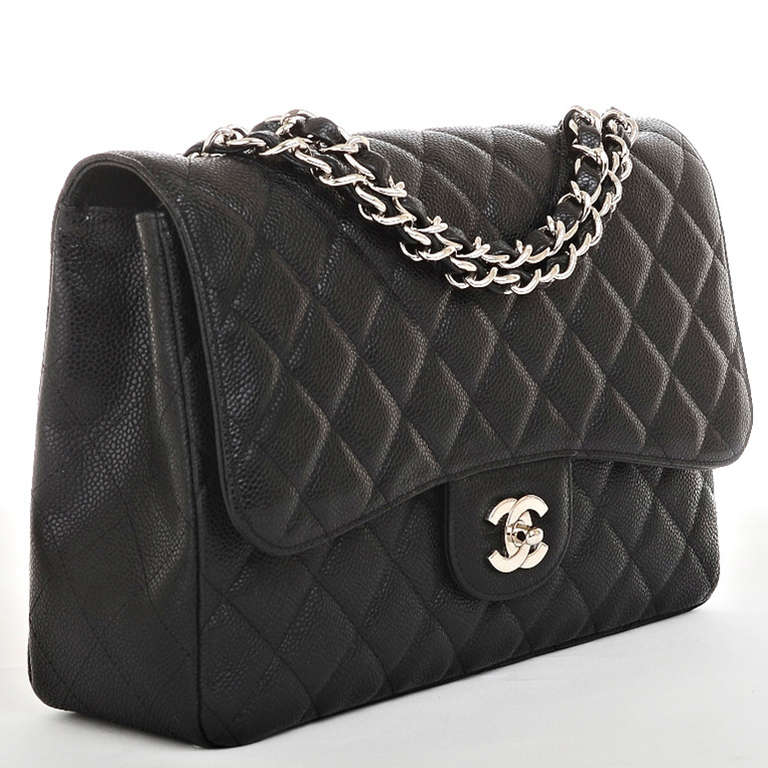Chanel rare black quilted caviar leather jumbo flap bag with silvertone hardware, front CC turnlock, rear half moon pocket and interwoven silvertone chain link and black leather adjustable strap. Interior is lined in black leather with a rear wall