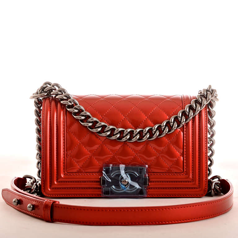 Chanel metallic red quilted patent leather Small Boy Bag with ruthenium hardware, metallic red lambskin gussets and bottom, front flap with CC push lock closure and ruthenium chain link and red leather padded shoulder strap. Interior is lined in