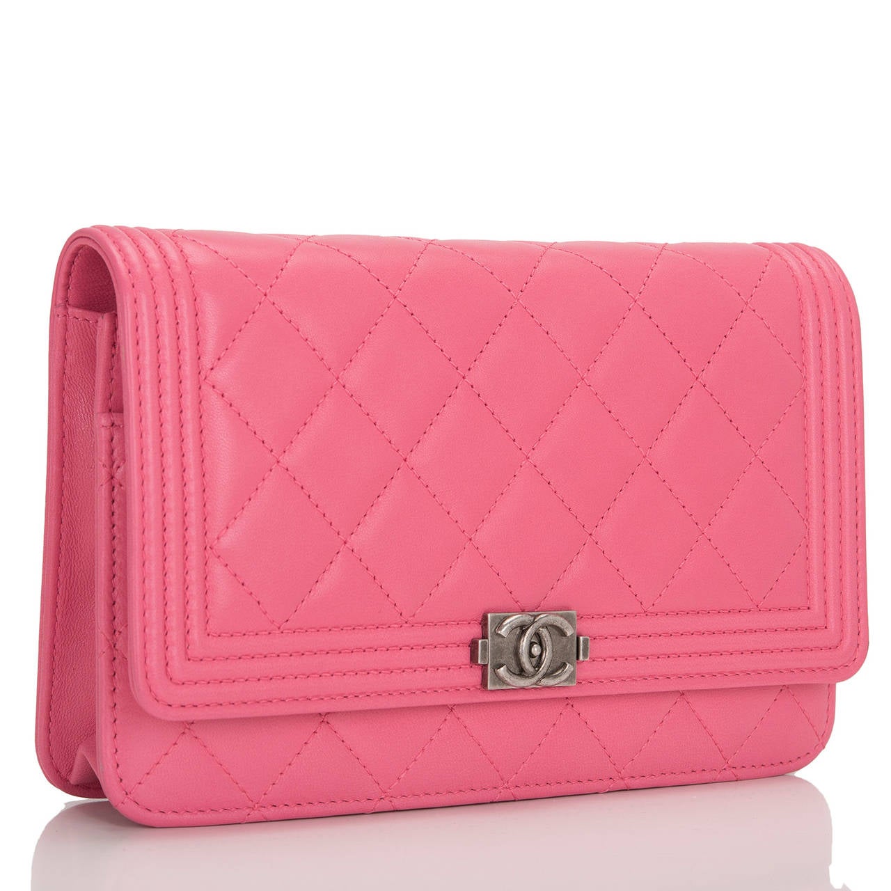 This gorgeous Chanel Pink Quilted Lambskin Le Boy Wallet on Chain with aged ruthenium hardware features a front flap with the signature Le Boy CC charm and hidden snap closure and aged ruthenium chain link and pink leather shoulder/crossbody strap