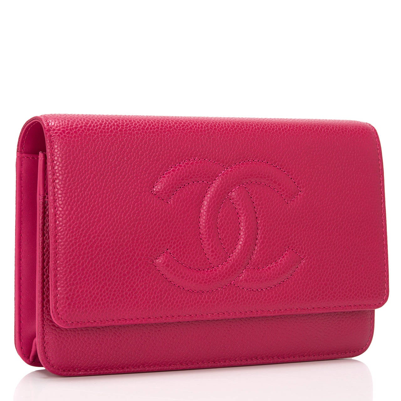 This Timeless Wallet On Chain (WOC) in a dark pink caviar with silver tone hardware features a front flap with tonal stitched large CC, hidden snap closure, expandable sides and bottom, and interwoven silver tone and dark pink leather