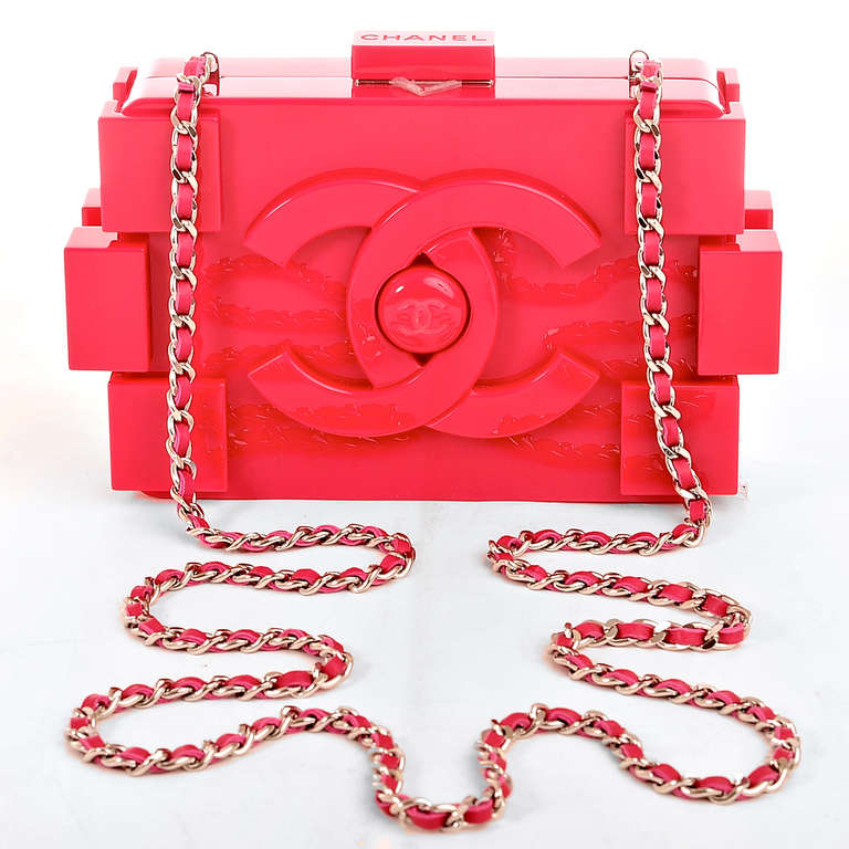 Chanel Fuchsia Pink Lego Clutch Boy Bag with large CC logo with CC center on front and back, and interwoven silvertone chain link and fuchsia pink leather shoulder/crossbody strap which can be tucked inside and worn as a clutch. Interior is lined in