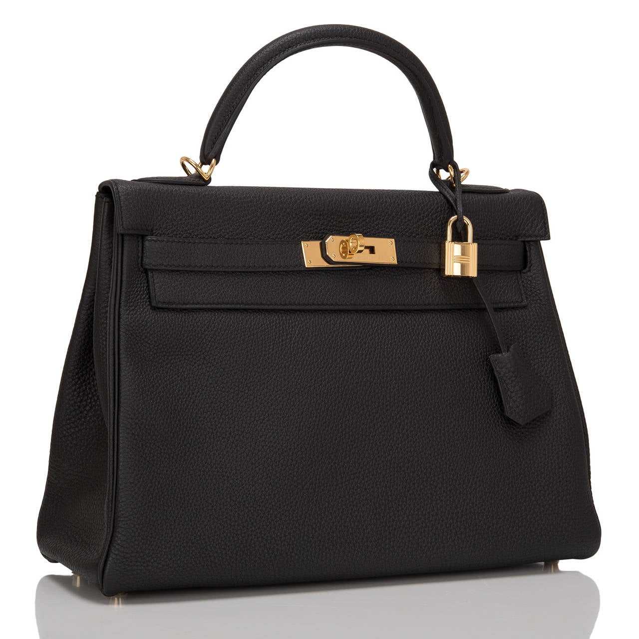 Hermes Black Kelly 32cm in rich togo (bull) leather with gold hardware.

This Kelly features tonal stitching, front toggle closure, a clochette with lock and two keys and a single rolled handle. The interior is lined in black chevre and features
