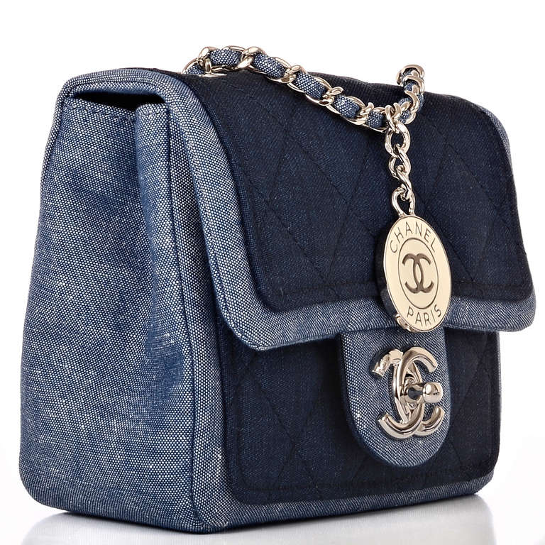 Chanel Denim Graphic Small flap bag featuring quilted indigo denim on blue denim body with silvertone hardware, front flap with CC turnlock closure and interwoven silvertone chain link and denim shoulder/crossbody strap with dangling Chanel CC