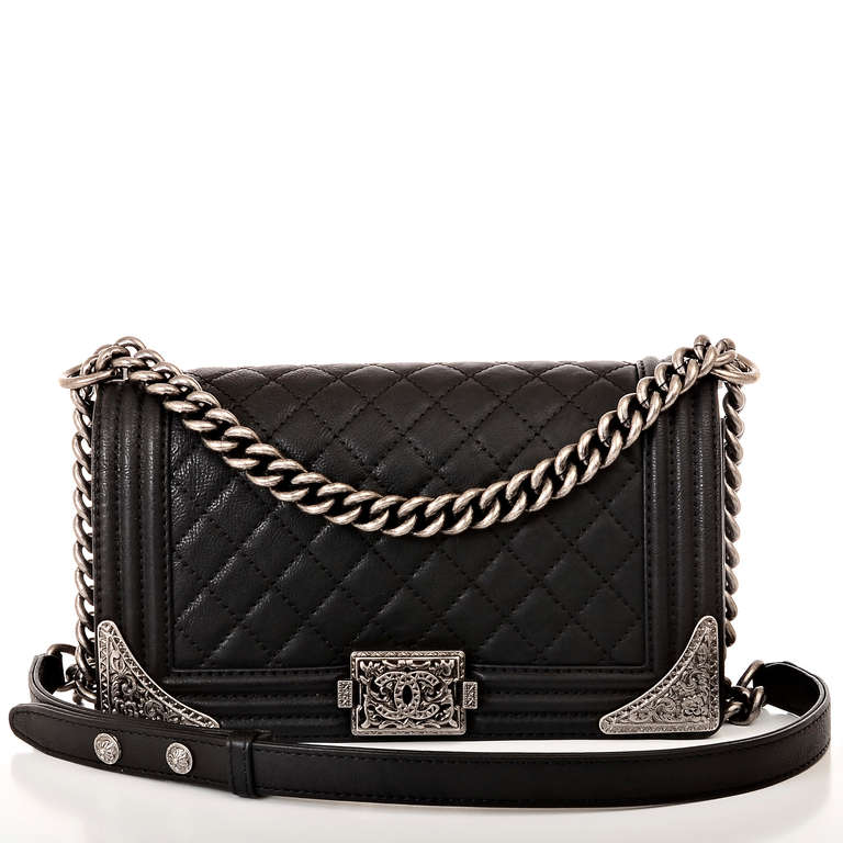 Chanel black quilted calfskin leather Medium Boy Bag with aged ruthenium hardware, front flap with CC push lock closure, tapered metal corner details and ruthenium chain link and black leather padded shoulder strap. Interior is lined in black fabric