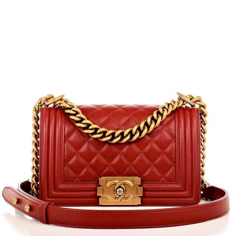 Chanel red quilted lambskin leather Small Boy Bag with antiqued gold hardware, front flap with CC push lock closure and goldtone chain link and red leather padded shoulder strap. Interior is lined in red fabric with open pocket on rear wall.