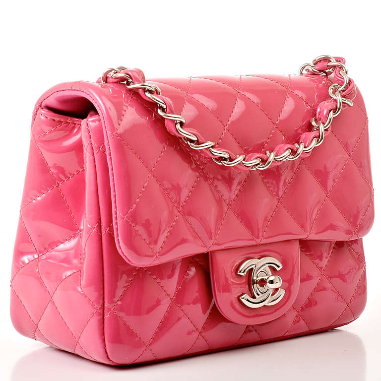 Chanel fuchsia pink quilted patent leather Mini classic 2.55 flap bag with silvertone hardware, front flap with CC turnlock closure, half moon back pocket and interwoven silvertone chain link and red leather shoulder/crossbody strap. Interior is
