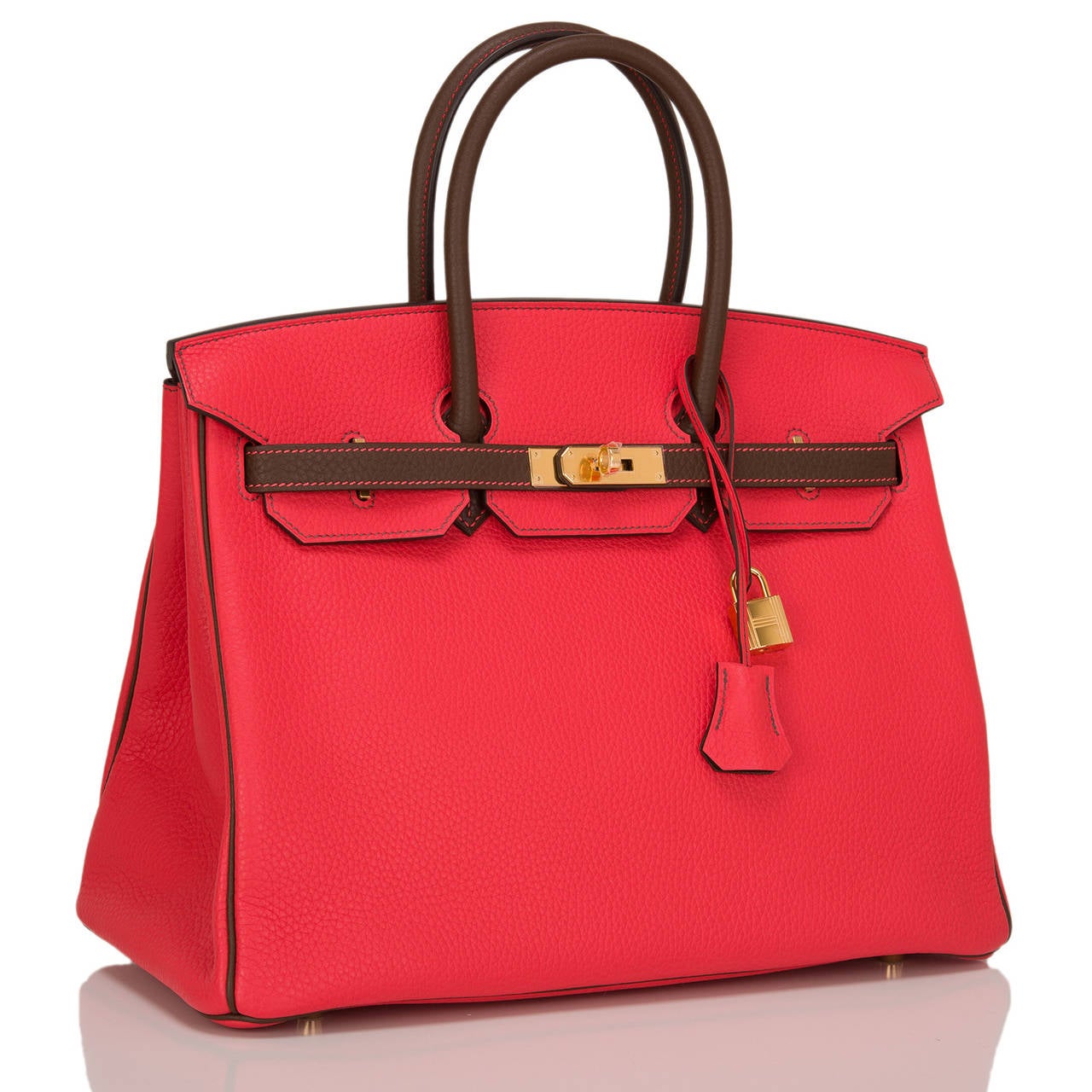 Hermes SO horseshoe (special order) bi-color Rouge Pivione and Cacao Birkin 35cm in togo (bull) leather with gold hardware.

This Birkin features tonal stitching, signature front toggle closure, a clochette with lock and two keys, and double