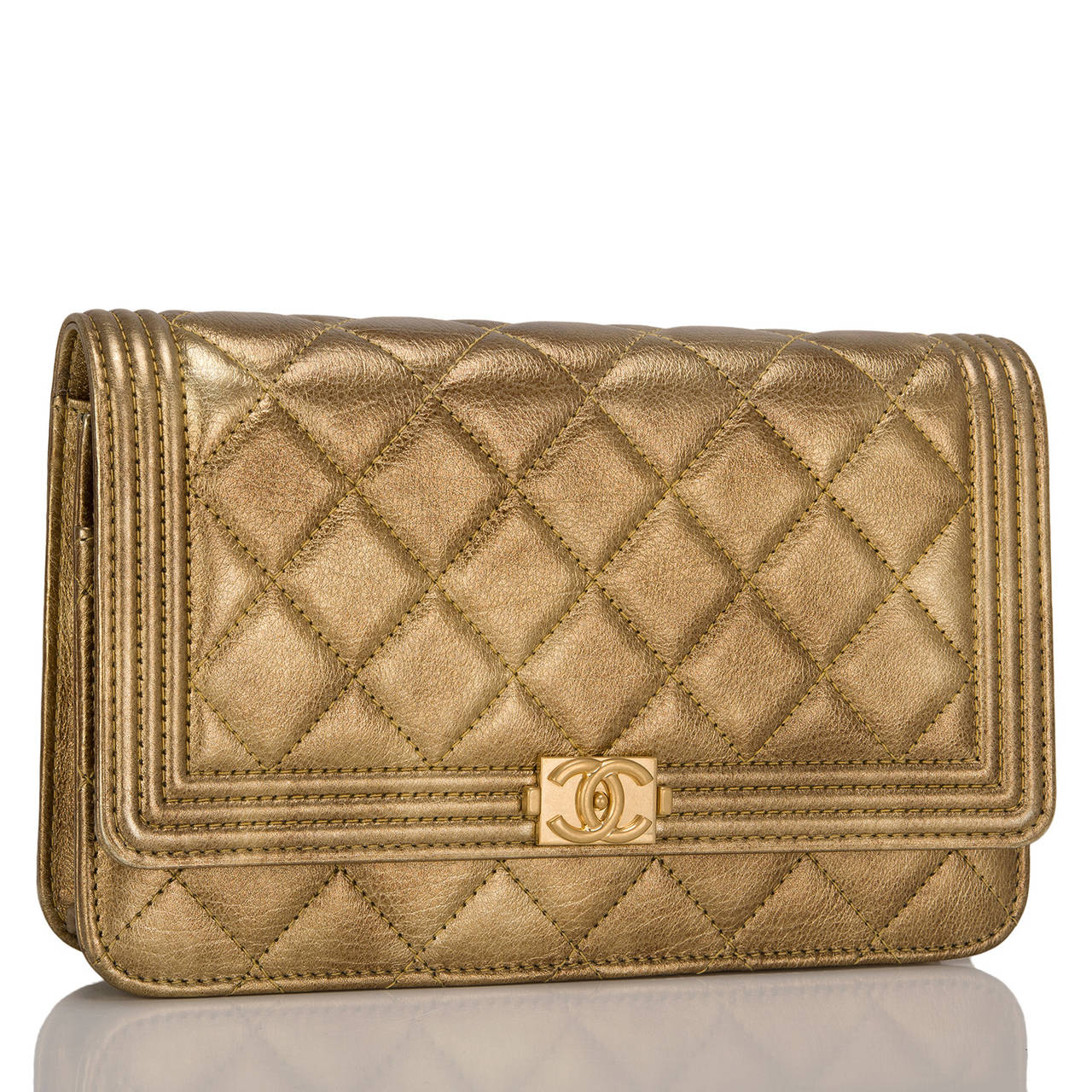 This gorgeous Gold Chanel Quilted Le Boy Wallet on Chain of distressed calfskin with aged gold tone hardware features a front flap with the signature Le Boy CC charm and hidden snap closure and gold tone metal chain link and gold leather