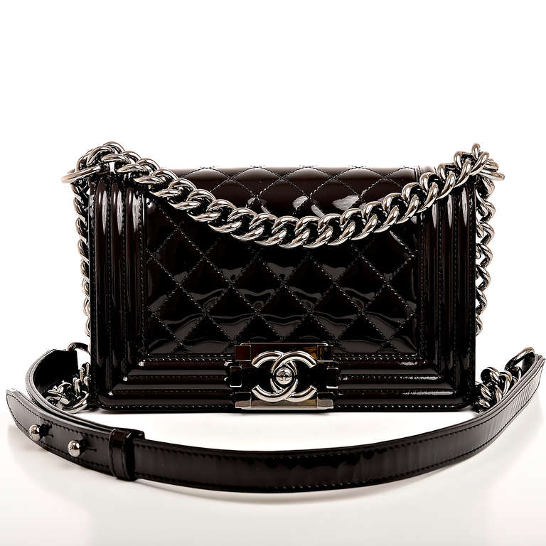 Chanel black quilted patent leather Small Boy Bag with ruthenium hardware, front flap with CC push lock closure and ruthenium chain link and black leather padded shoulder strap. Interior is lined in black fabric with open pocket on rear wall.