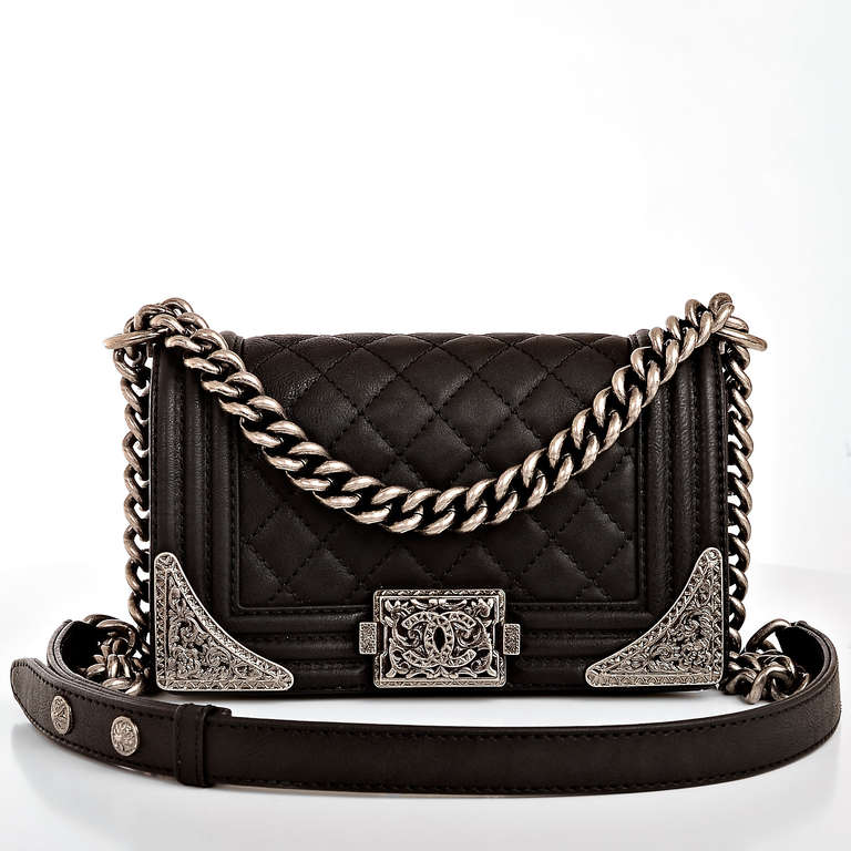 Chanel black quilted calfskin leather Small Boy Bag with aged ruthenium hardware, front flap with CC push lock closure, tapered metal corner details and ruthenium chain link and black leather padded shoulder strap. Interior is lined in black fabric