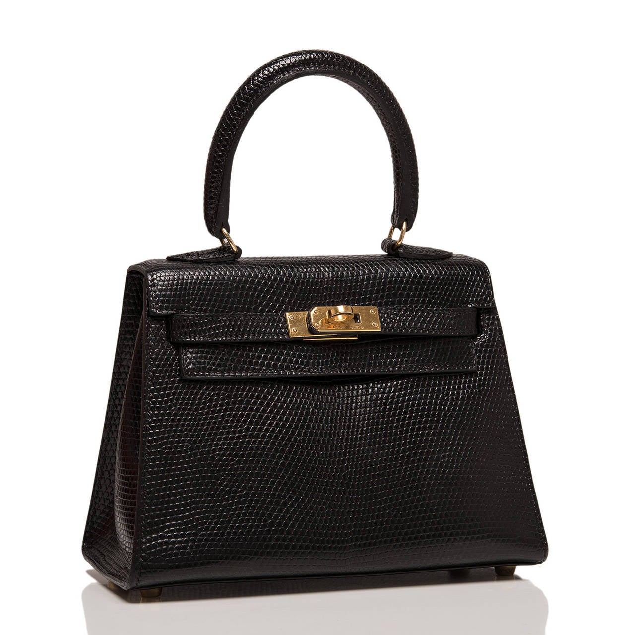 Hermes Black Kelly 20cm in luxurious lizard skin with gold hardware.

This rare mini 20cm kelly in luxurious black lizard has just returned from Hermes' spa and is beautiful with its gold hardware.

This Hermes Kelly features tonal stitching,