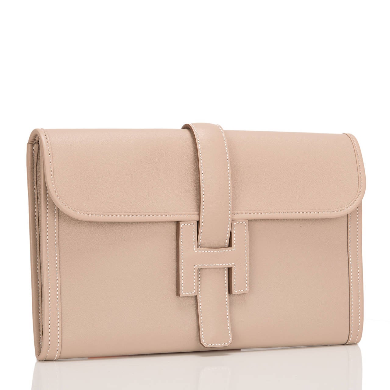 Hermes Argile swift leather Jige PM clutch.

This style features white contrast stitching and front 