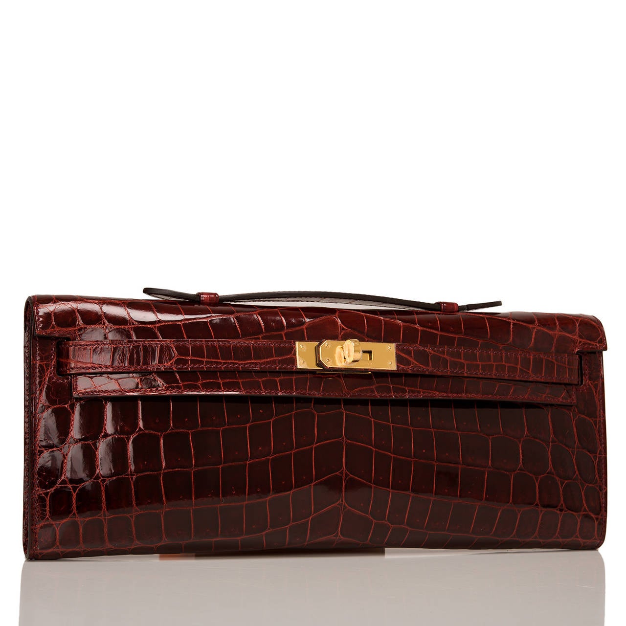 Hermes Bordeaux shiny niloticus crocodile Kelly Cut

This Kelly Cut in a fall 2015 favorite color -- Bordeaux -- is a gorgeous deep burgundy that is elegant with rare Nilo crocodile skin and gold hardware; the bag has tonal stitching, front straps