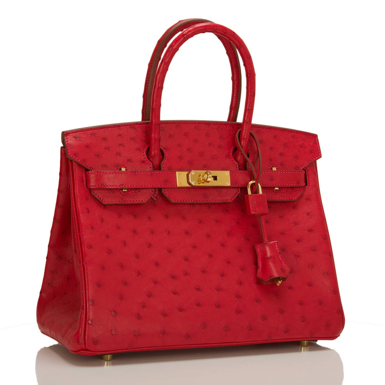 Hermes Rouge Vif 30cm in Ostrich with gold hardware.

This Birkin features tonal stitching, front toggle closure, clochette with lock and two keys, and double rolled handles. The interior is lined in Rouge Vif chevre with one zip pocket with an