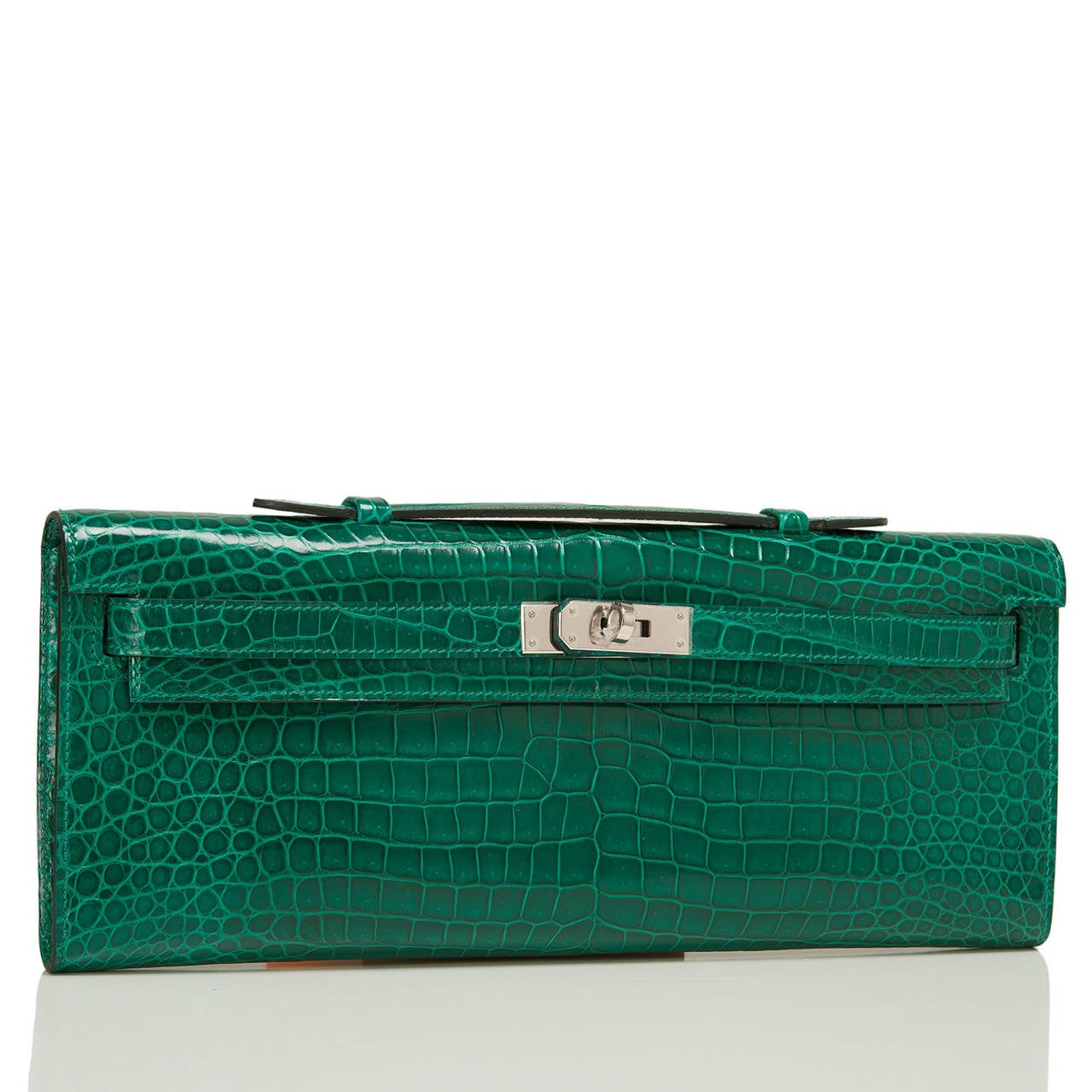 Hermes Emerald Porosus Crocodile Kelly Cut with palladium hardware.

This exotic Kelly Cut of Emerald Green Shiny Porosus crocodile is a gorgeous treasure, paired with complimenting palladium hardware; the bag has tonal stitching, front straps