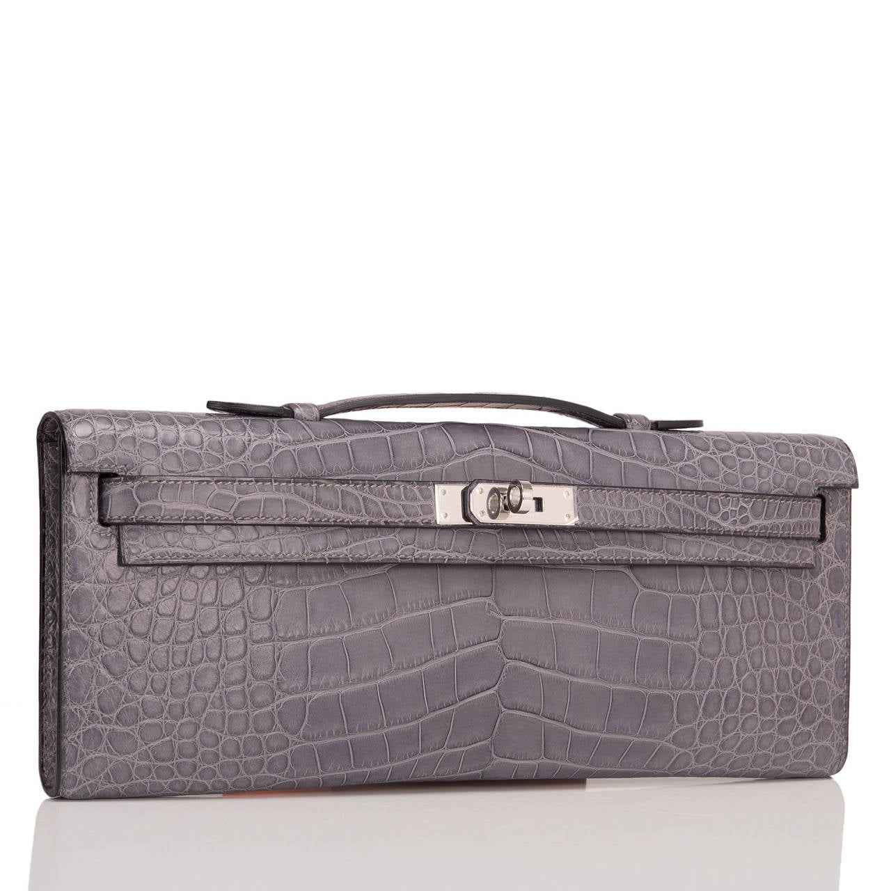 Hermes Gris Paris Matte Alligator Kelly Cut with palladium hardware.

This style features tonal stitching, front straps with toggle closure and a top flat handle.

The interior is lined in Gris Paris chèvre leather and features an open wall